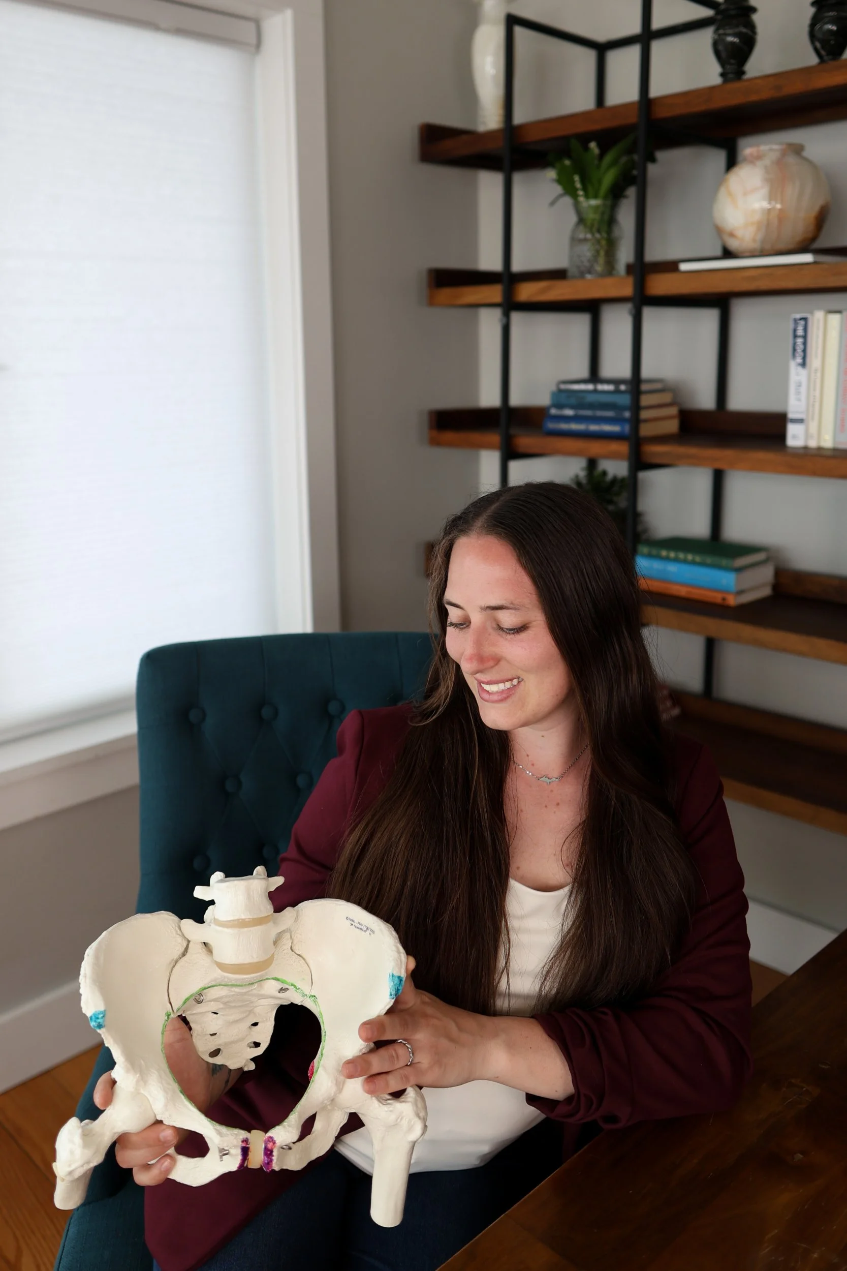 Lacy Anderson childbirth educator with a female pelvis.