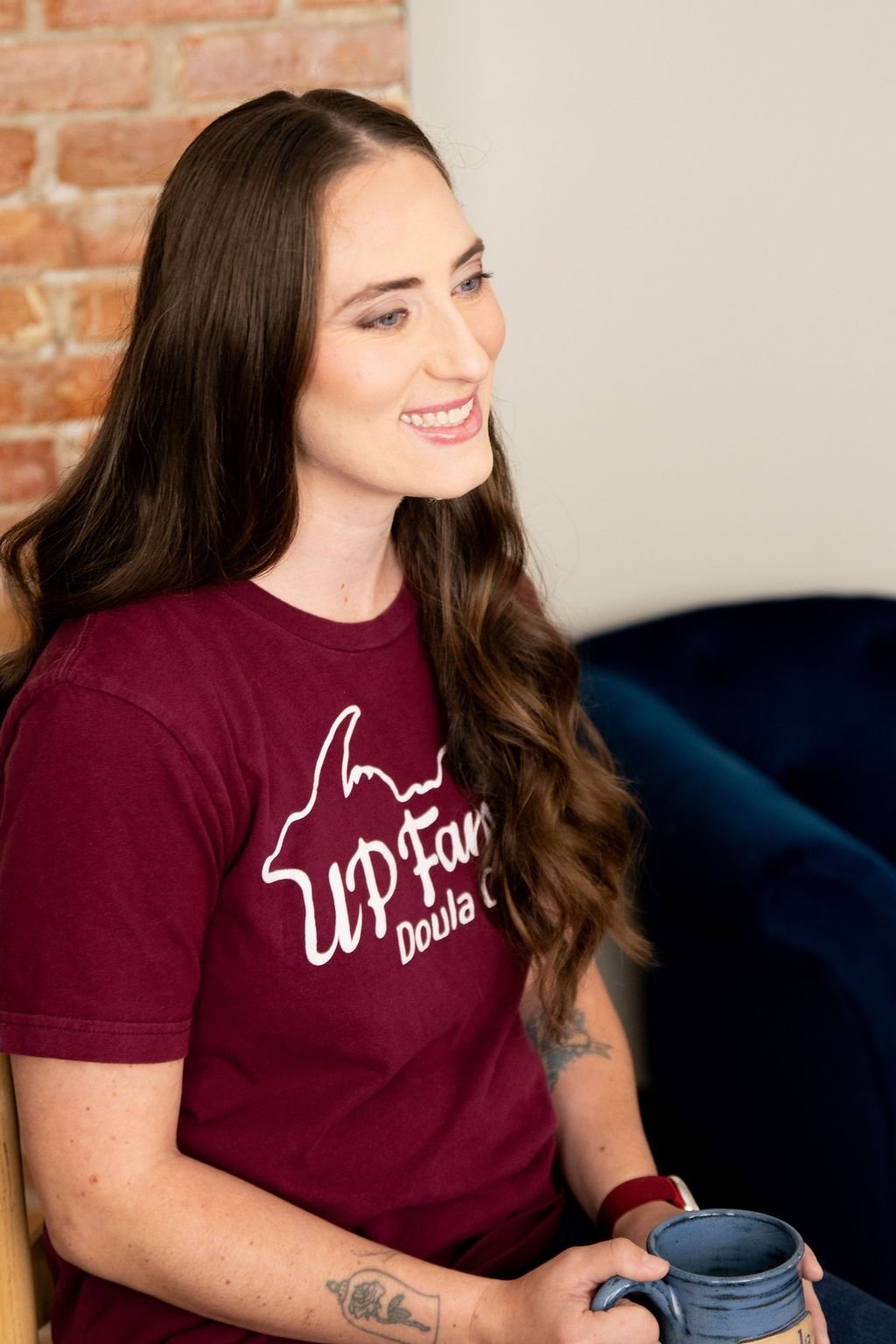 Lacy Anderson, certified birth doula in Marquette, poses for professional photography.