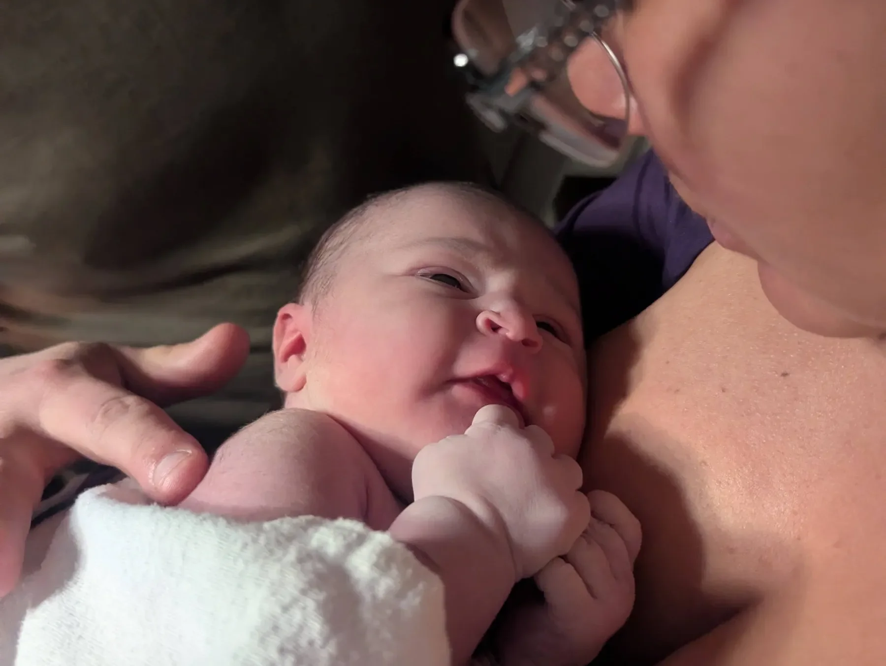 Postpartum doula at UP Family Doula Care supporting newborn at home in Marquette County, MI.