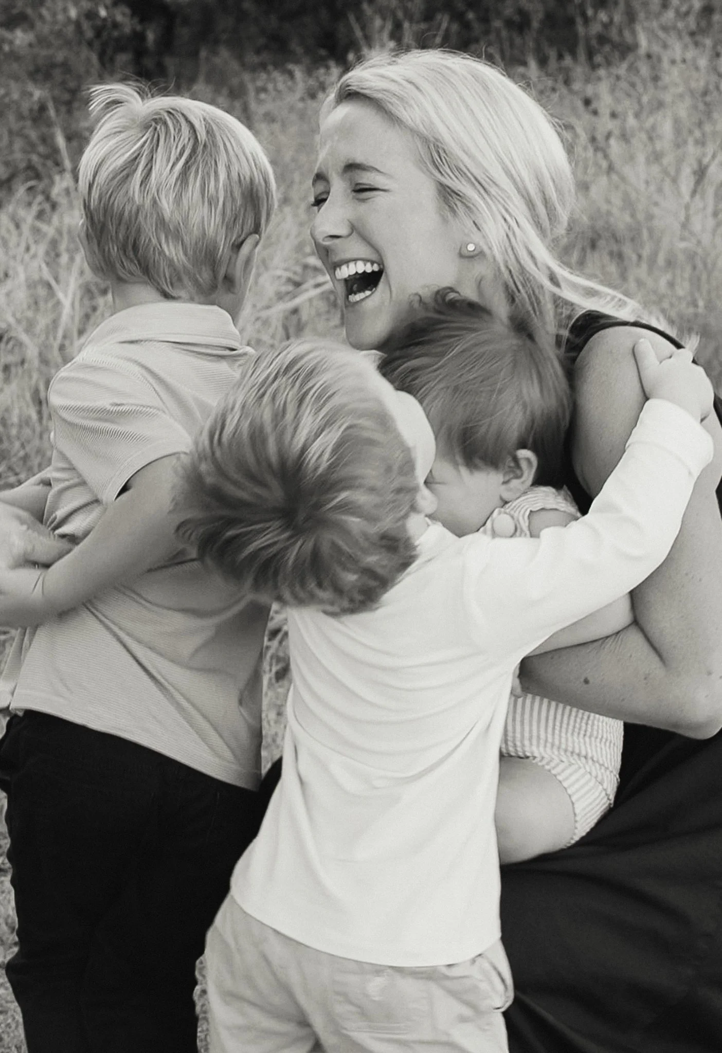 Laurie’s customers, Mariana and Carmen holding hands on a green lawn on their wedding day.