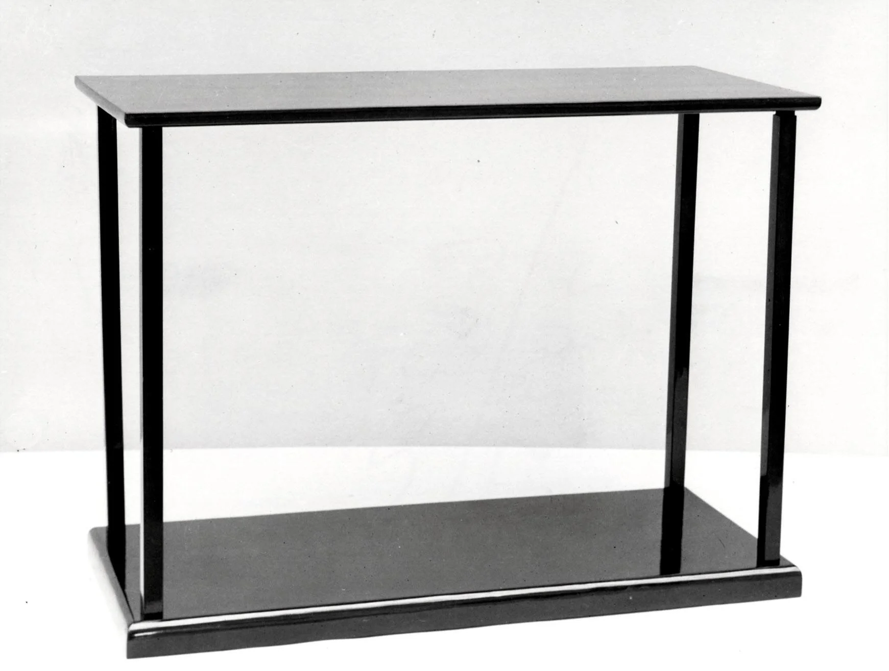 Table consisting of two rectangular, black lacquer, rectangular planes, connected by a slim round ebonized support at each cornerr