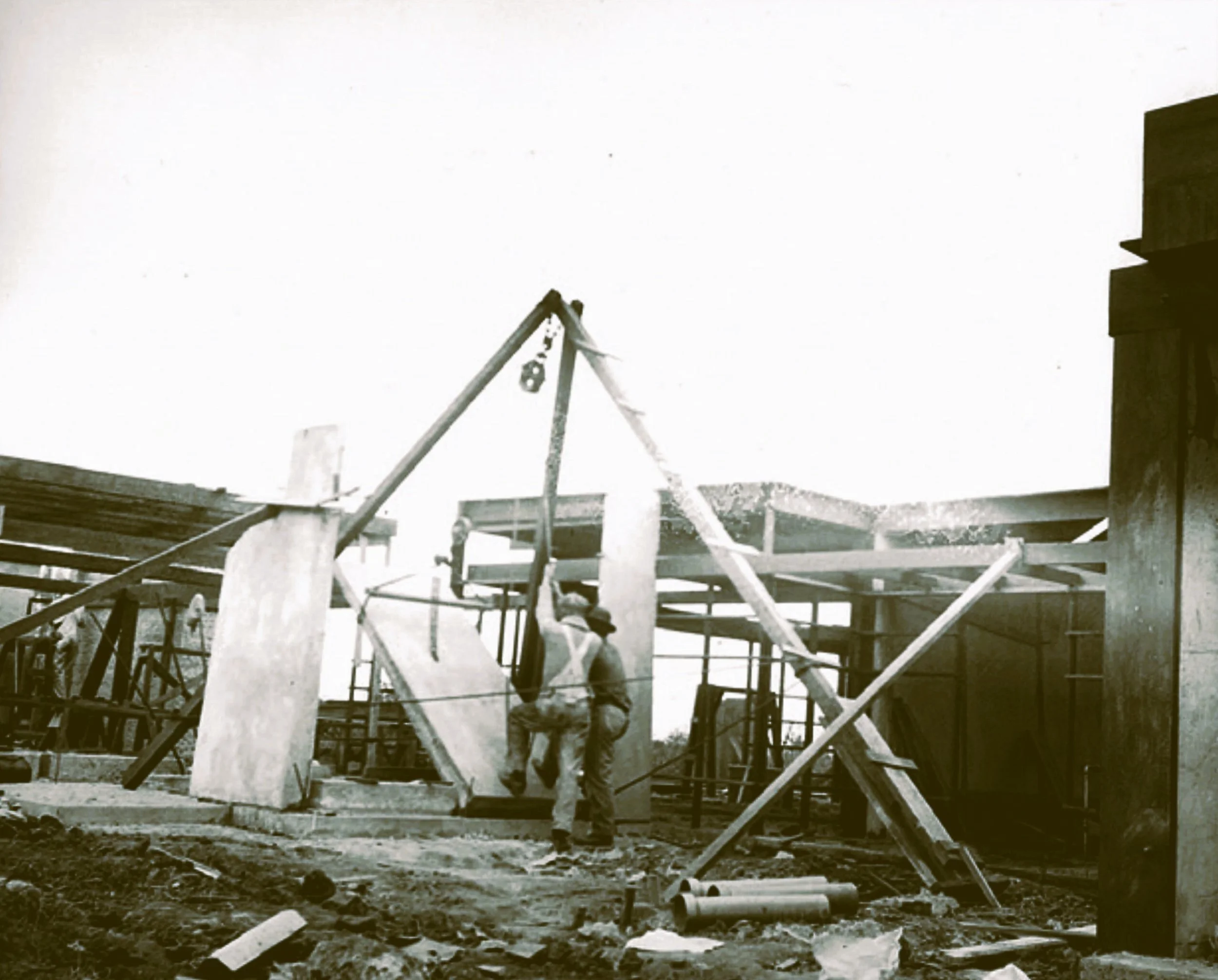 Historic photograph of the Schindler House under construction, showing exposed concrete walls, structural framing, and the building methods that reflect Schindler's commitment to truth in materials and truth in construction.