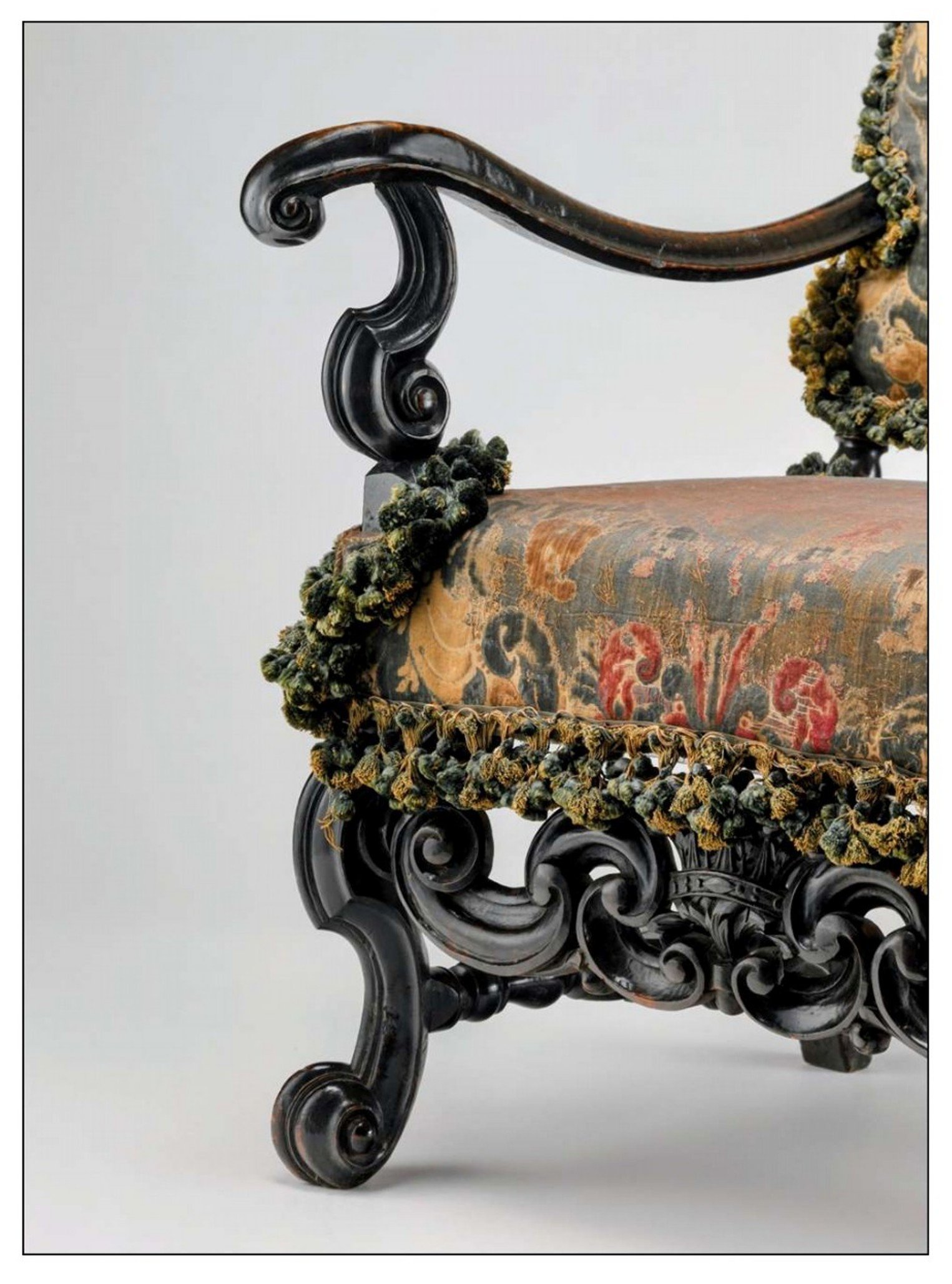 Detail of the arm, upright, leg, and stretcher, showing the elegant proportion and sweep of the arm