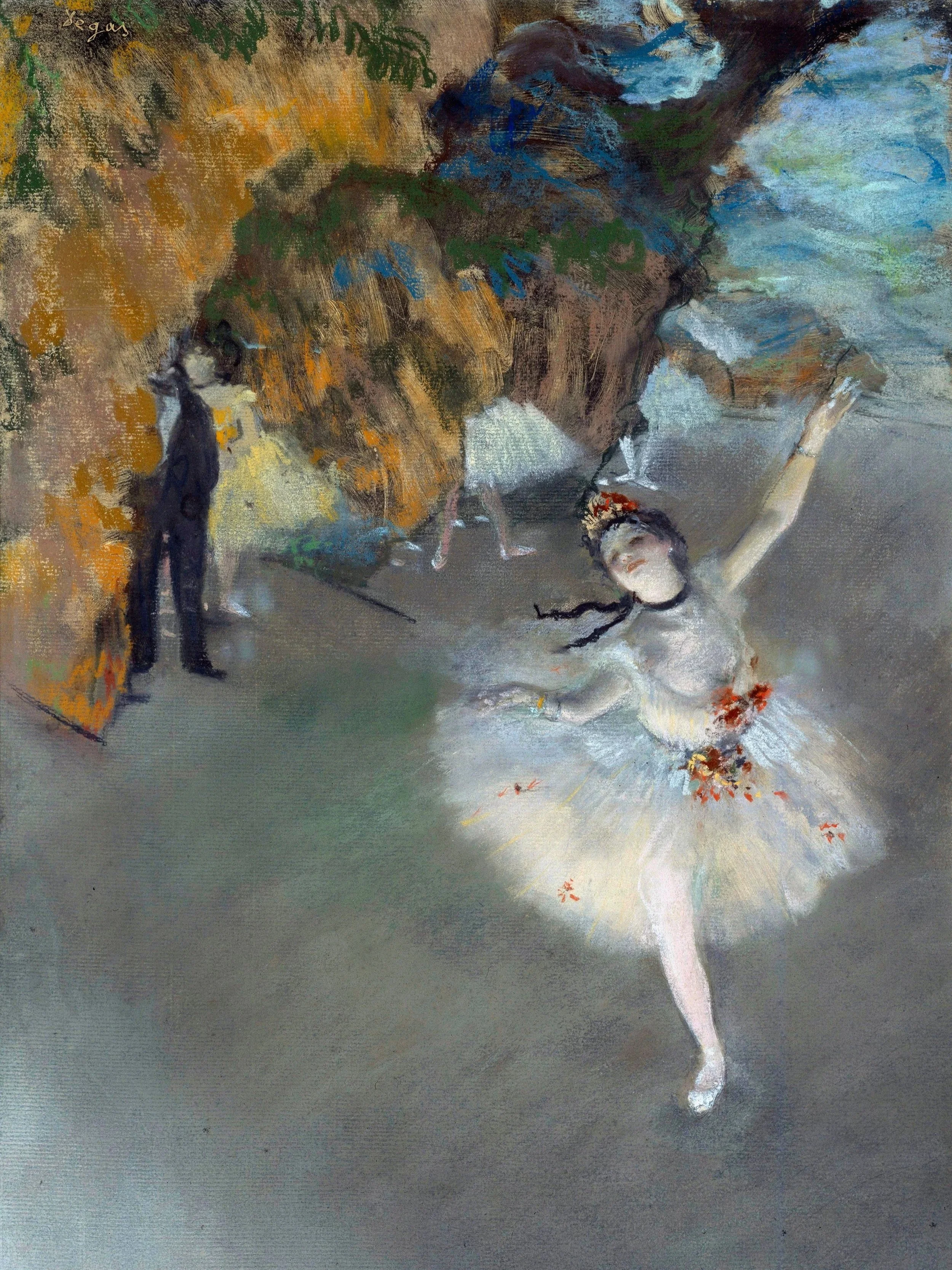Bird's eye view of a ballerina in white, highlighted by stage lights, against a blurred background of the stage