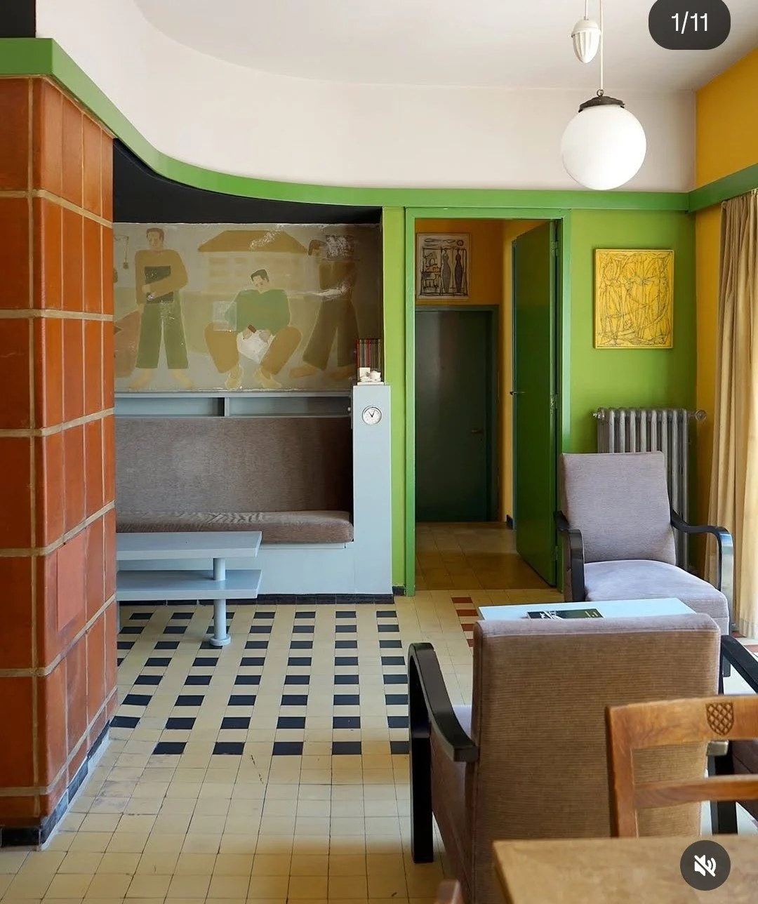 A minimal and geometric but rich  sitting room of multi colors, materials, textures, and art