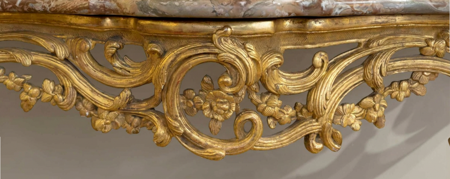 Detail of the motif at center of apron of Louis XV carved and gilded console table