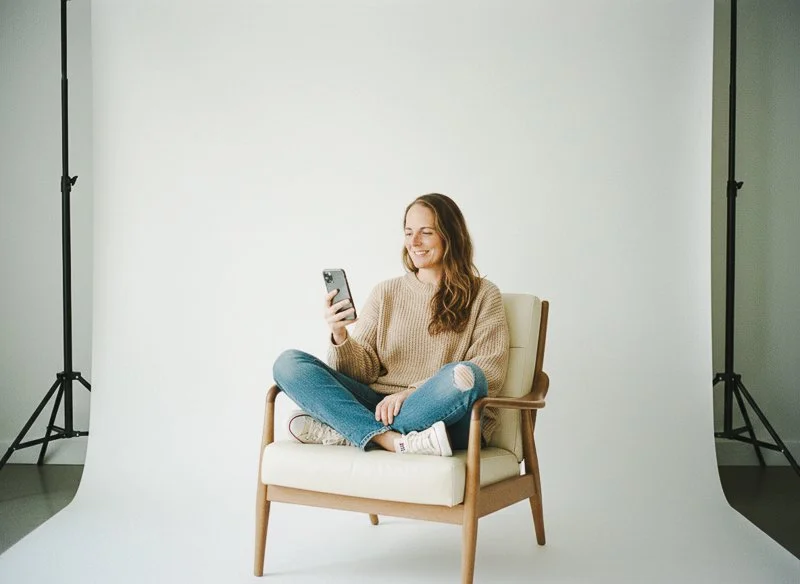 Social media manager, Liz, in her santa cruz studio reviewing content on her phone.