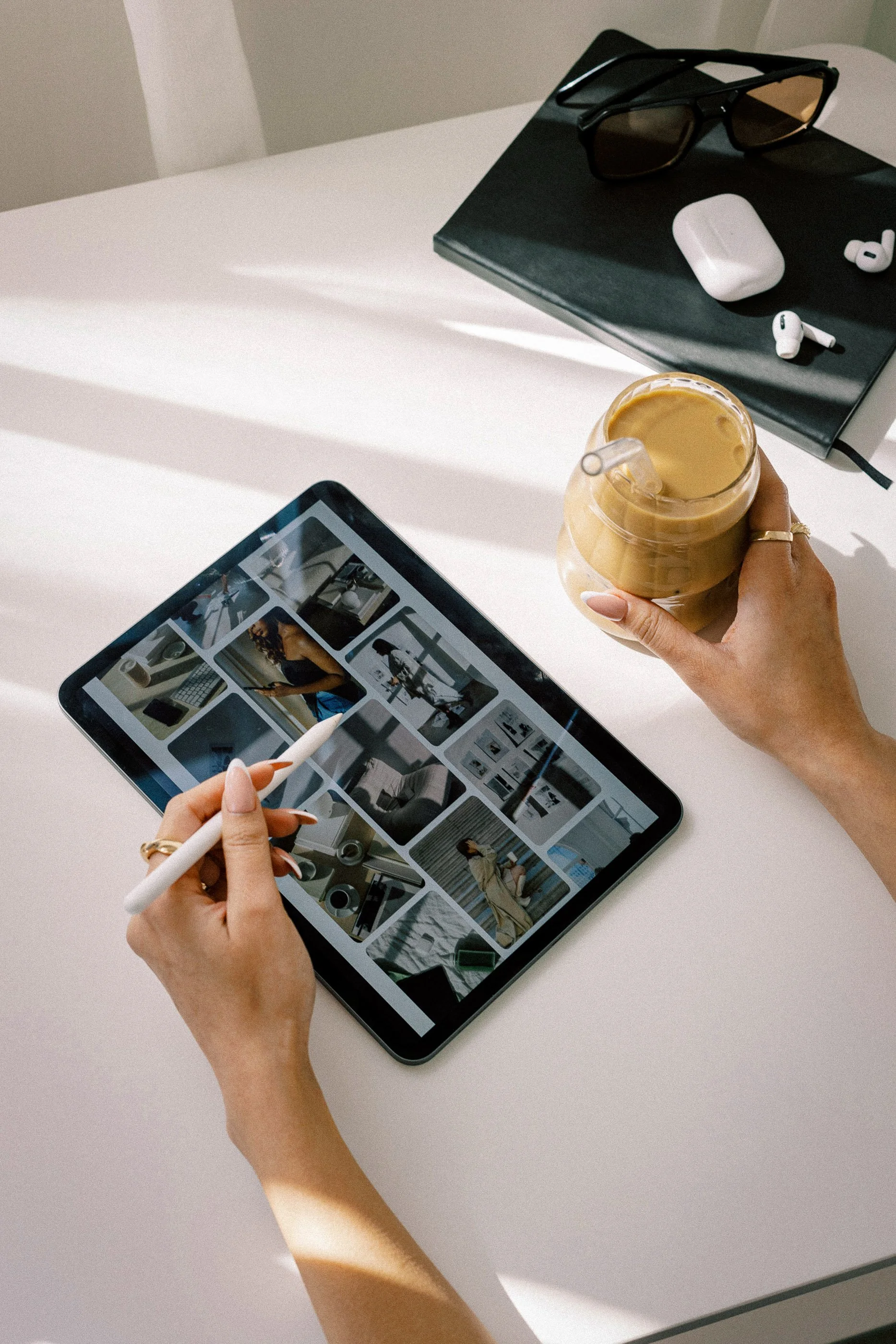 Social media manager planning content for a small business owner on an ipad.