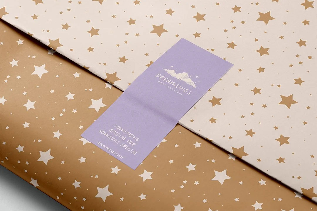 Kids clothing store branded gift wrap and sticker design featuring star patterns and pastel tones for a baby boutique.