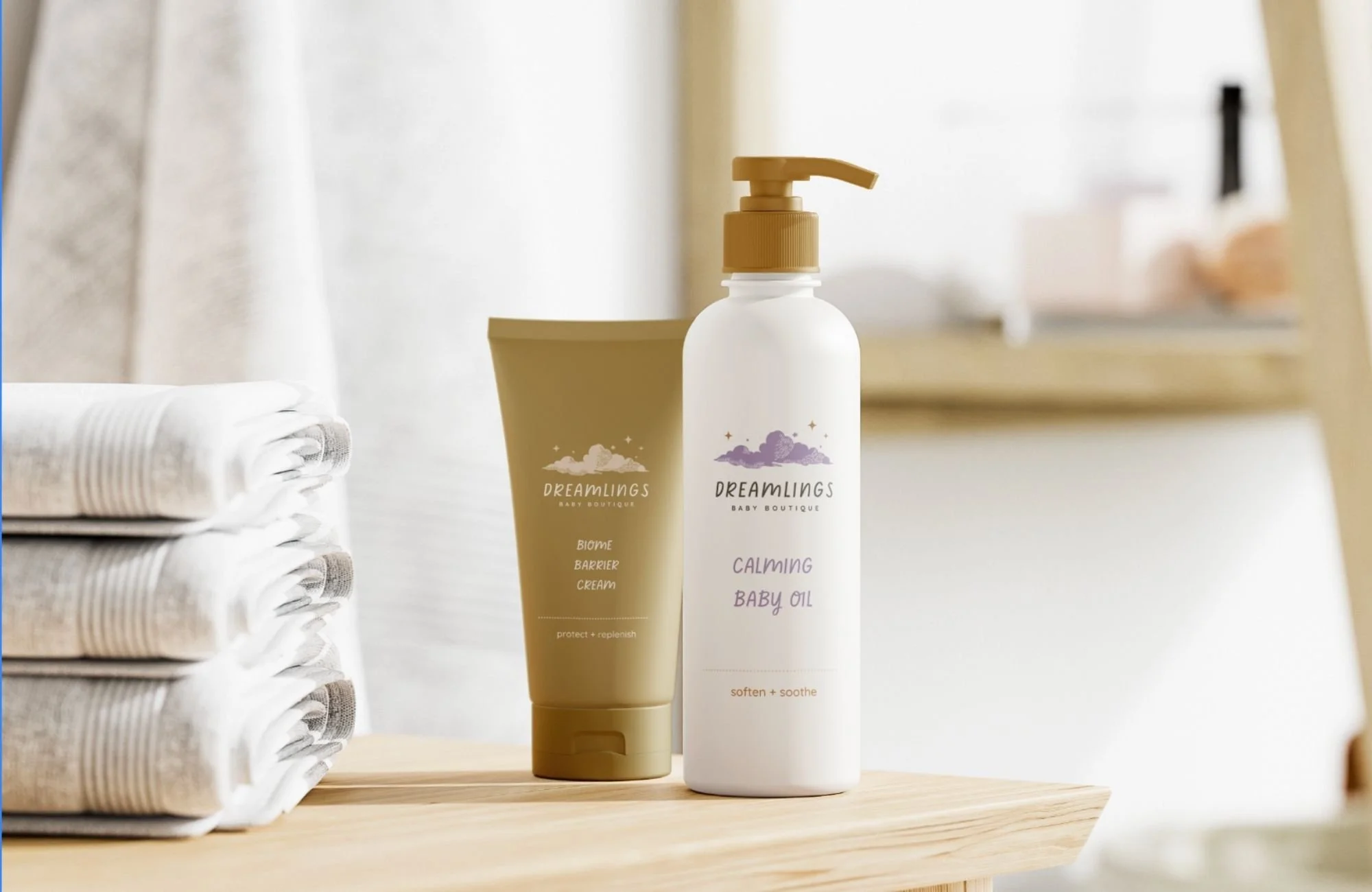 Dreamlings baby product packaging mockup with lotion bottles and gentle branding in soft pastel colors.