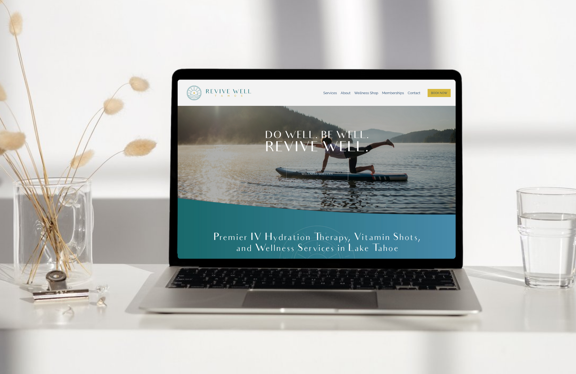 Modern wellness website homepage displayed on a laptop, featuring clean calming design for a health and wellness business.