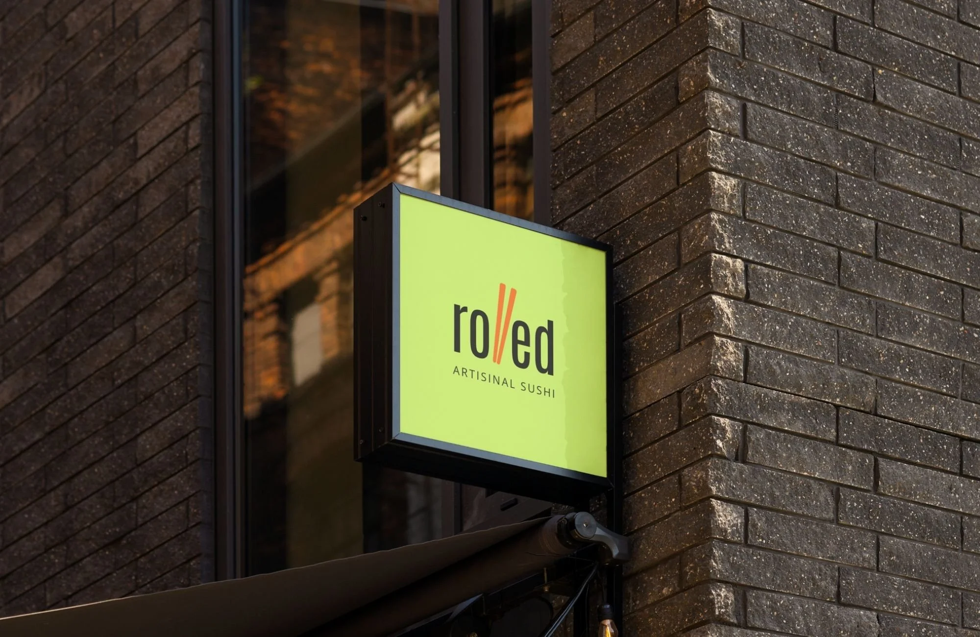 Illuminated exterior restaurant sign featuring a bold, modern sushi brand identity.