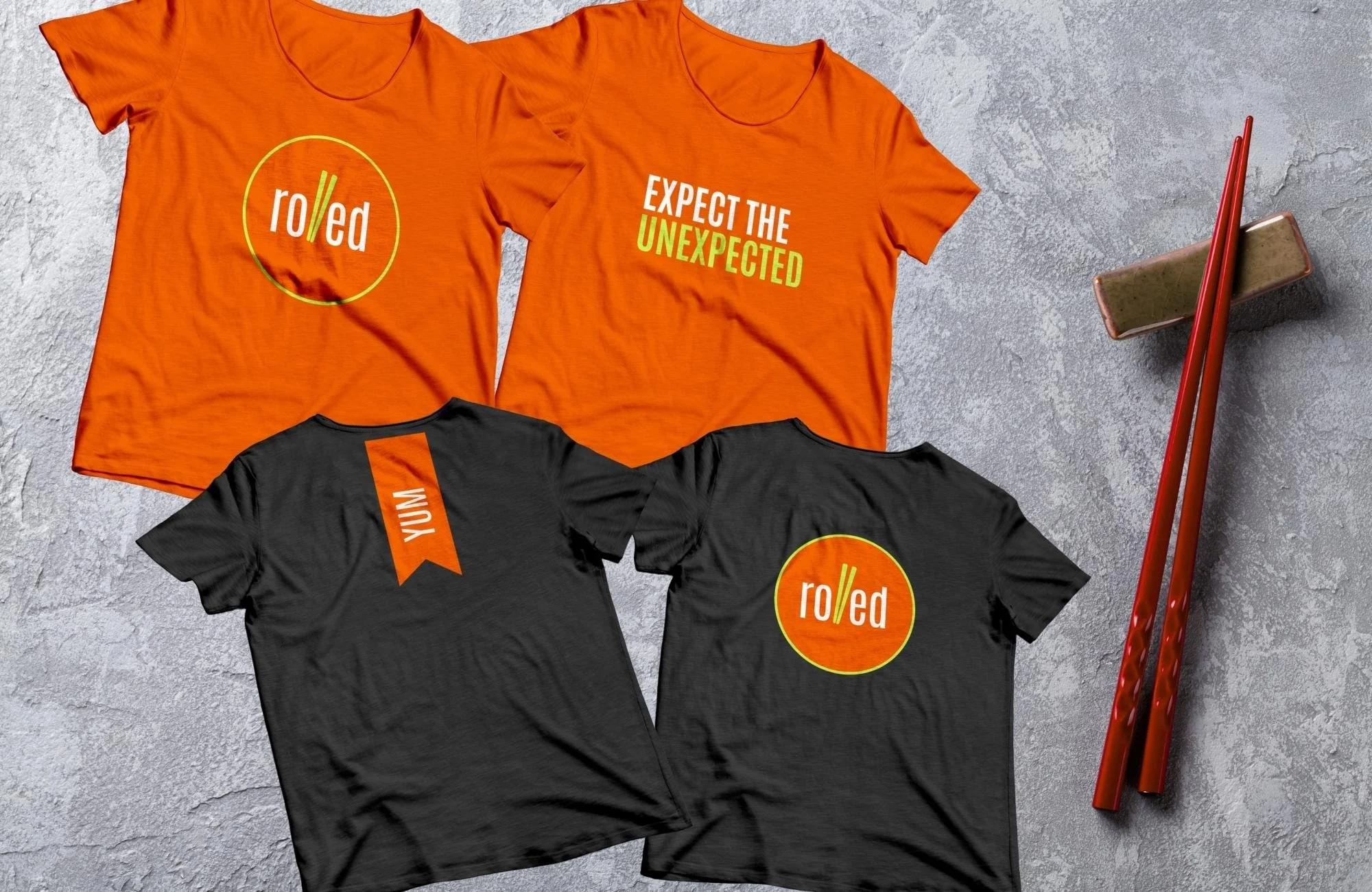 Branded apparel for a modern sushi restaurant, including graphic t-shirts and custom chopsticks.