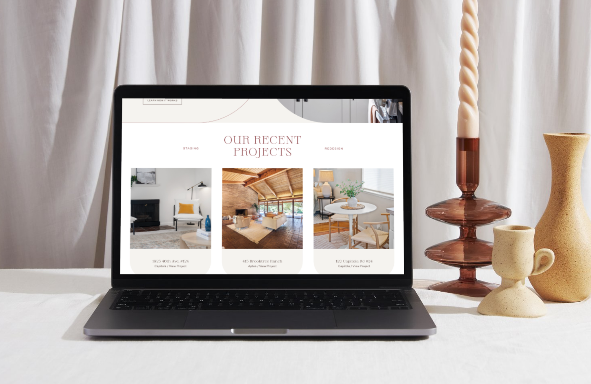 Home staging website design displayed on a laptop, showcasing a clean, modern layout for an interior design business.