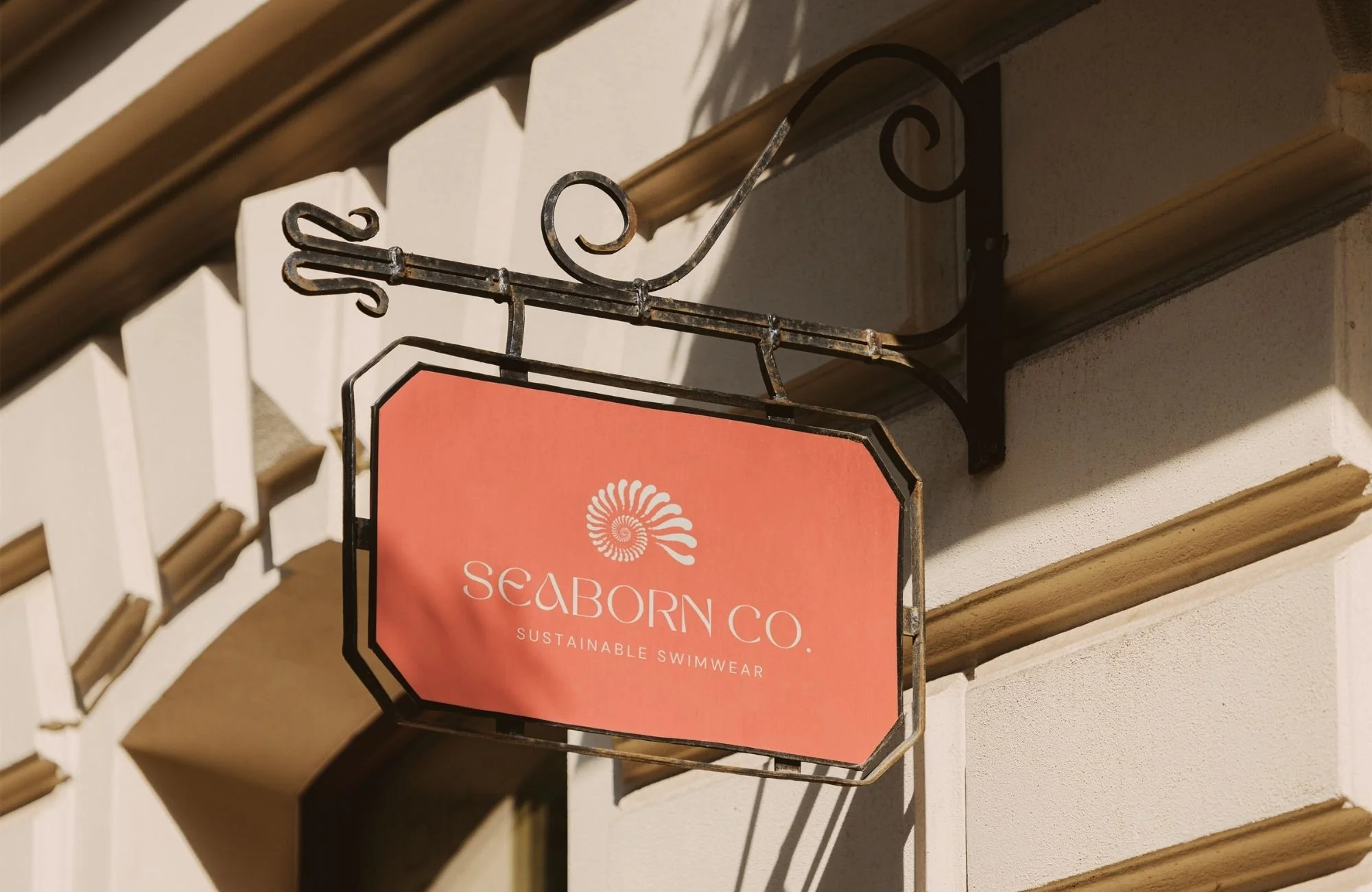 Storefront signage for sustainable swimwear brand with coastal-inspired logo and warm, modern brand colors.