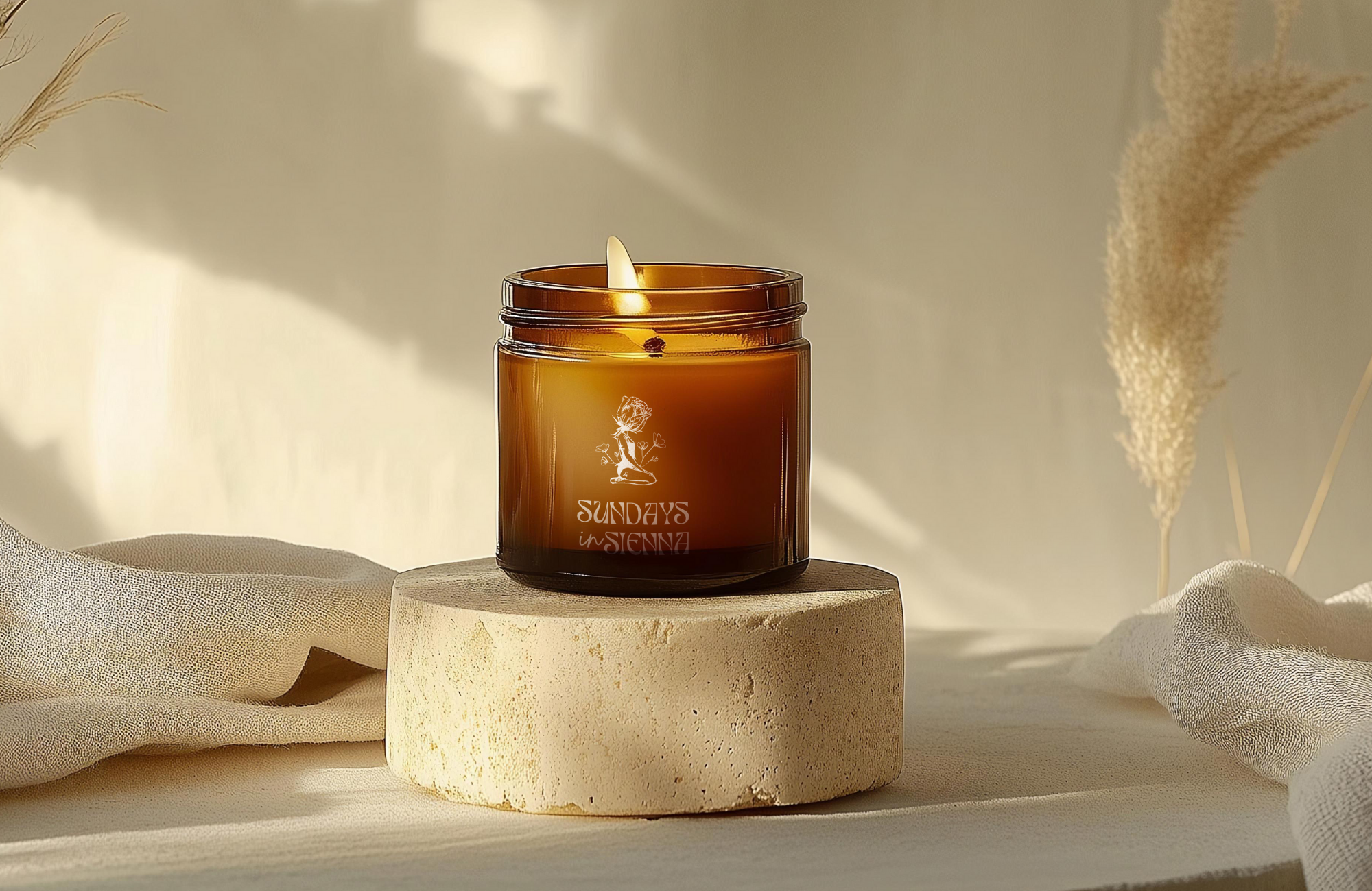 mber candle styled in soft natural light with warm, organic textures.