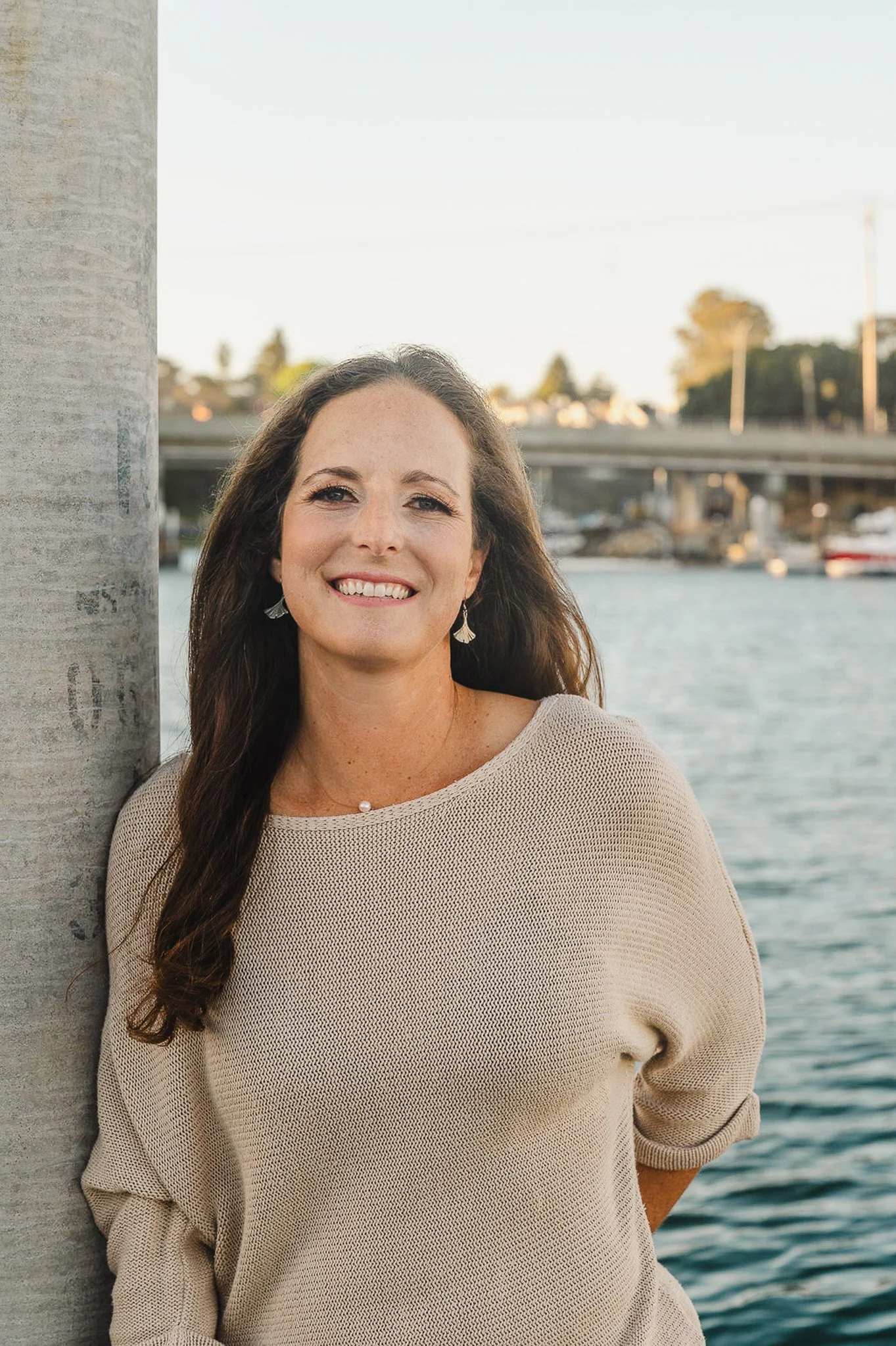 Liz, founder of Aviso Studios, smiling at the Santa Cruz Harbor — a brand and website designer serving small businesses in Santa Cruz, California.