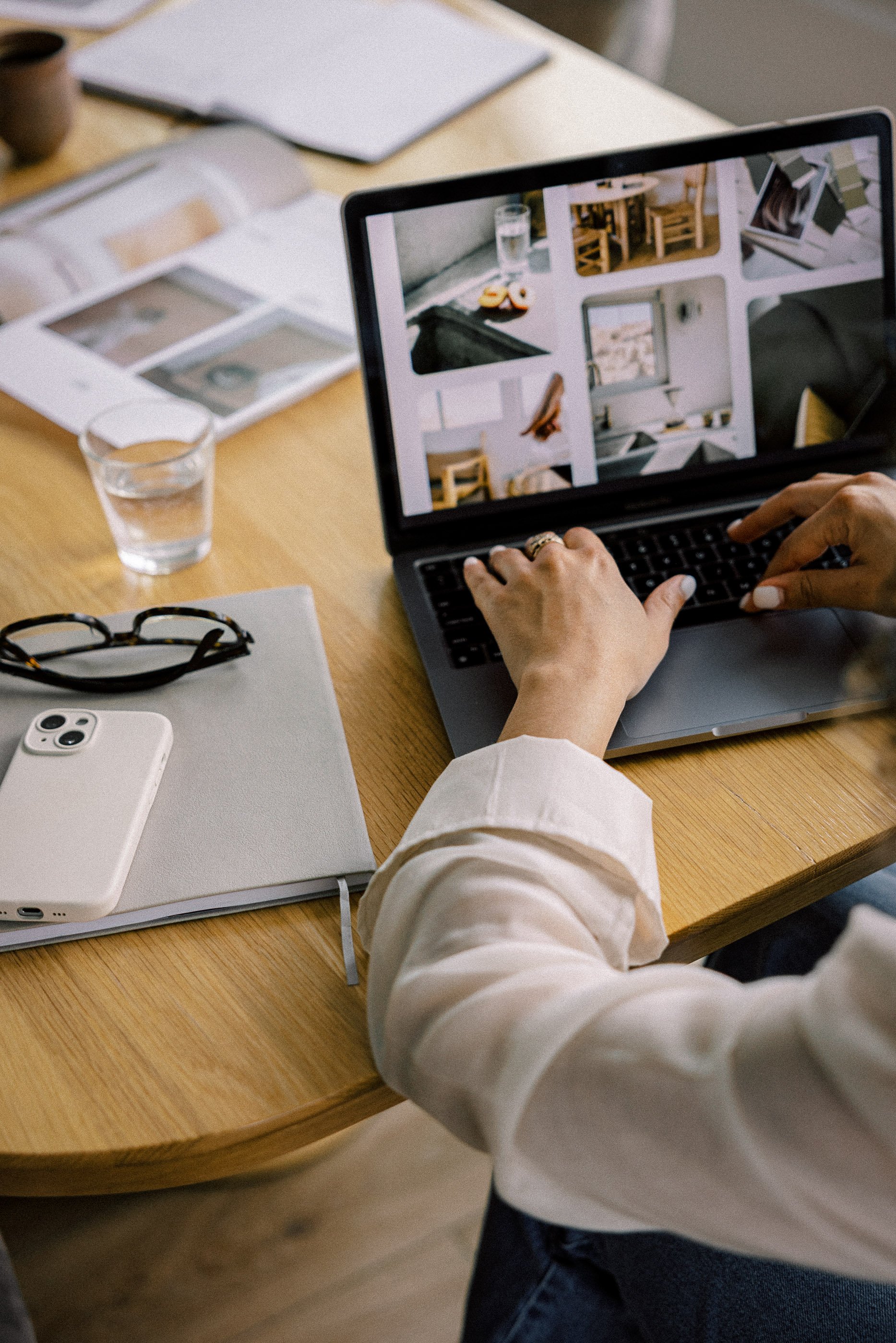 Website design workspace with a laptop and phone, representing custom small business website services by Aviso Studios in Santa Cruz California.