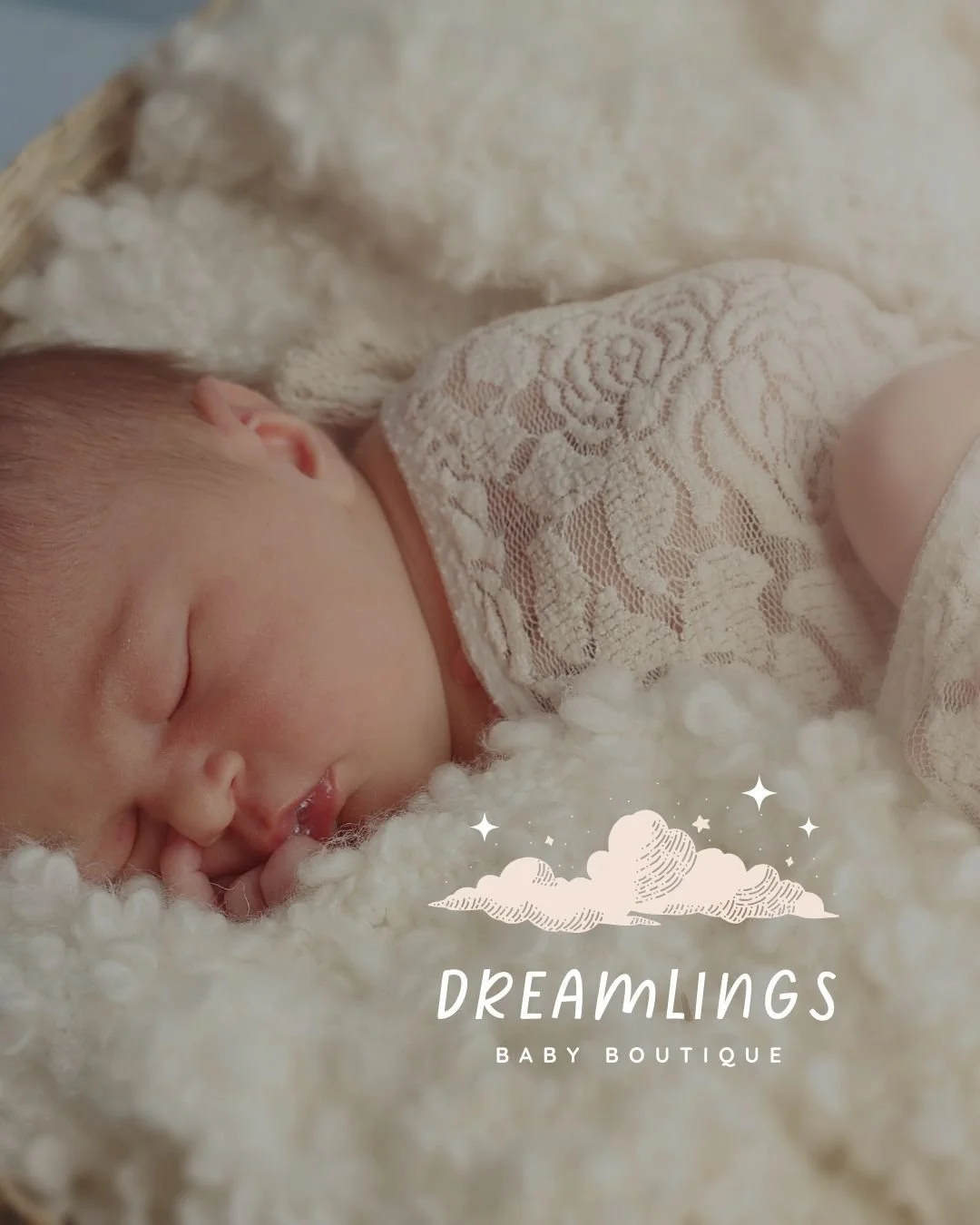 A sleeping baby wrapped in a lace blanket, featuring the Dreamlings Baby Boutique logo with a whimsical cloud design and soft pastel tones.