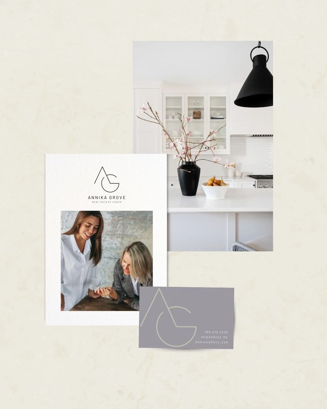Business cards and a flyer for Annika Grove, a real estate coach, displayed on a light-colored surface. The flyer shows a woman and a client in conversation. The background image is of a white kitchen with a black vase of pink flowers, a bowl of fruit, and a black pendant light.
