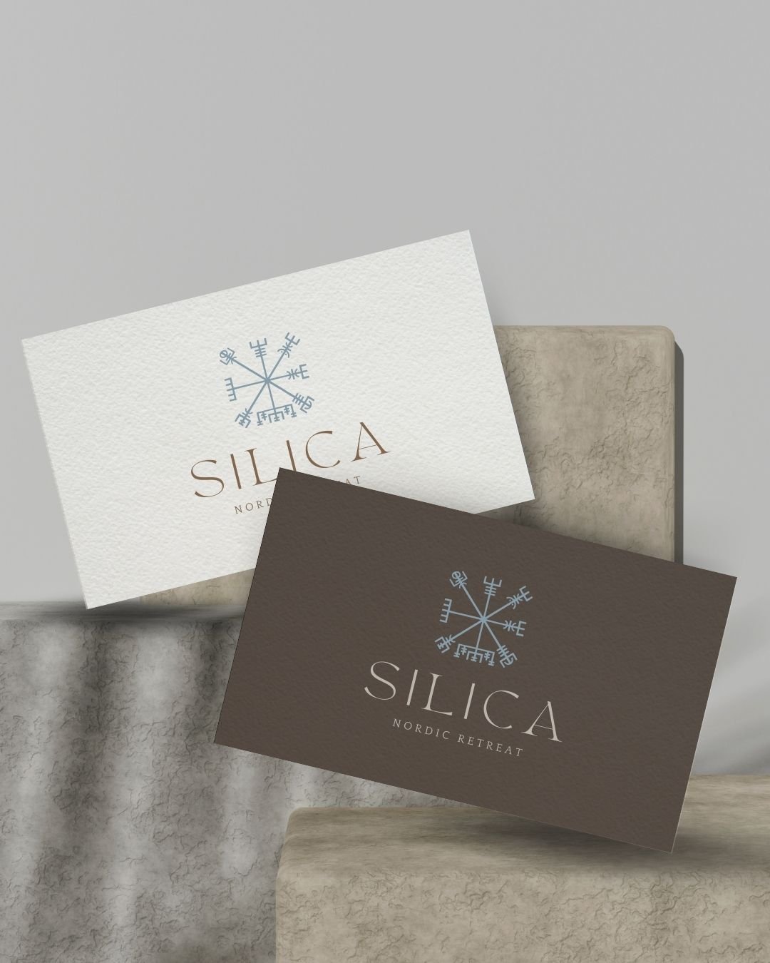 Minimalist business cards for Silica Spa with the Nordic-inspired logo and elegant typography in earthy and white tones.