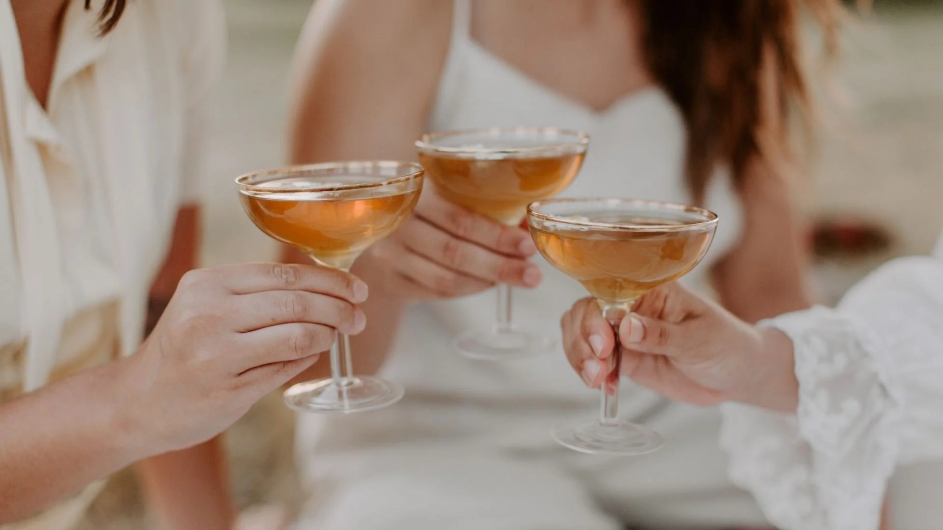 People holding champagne glasses in a toast during a business launch celebration.