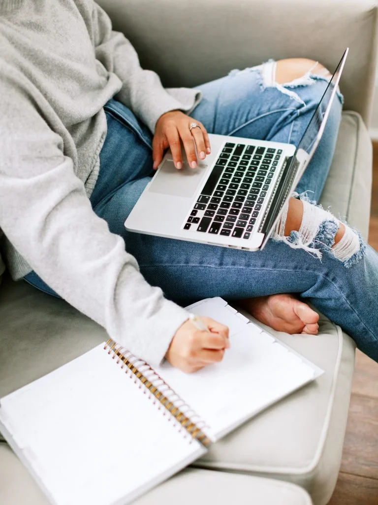 Business owner writing an outline of her website words so they sell.