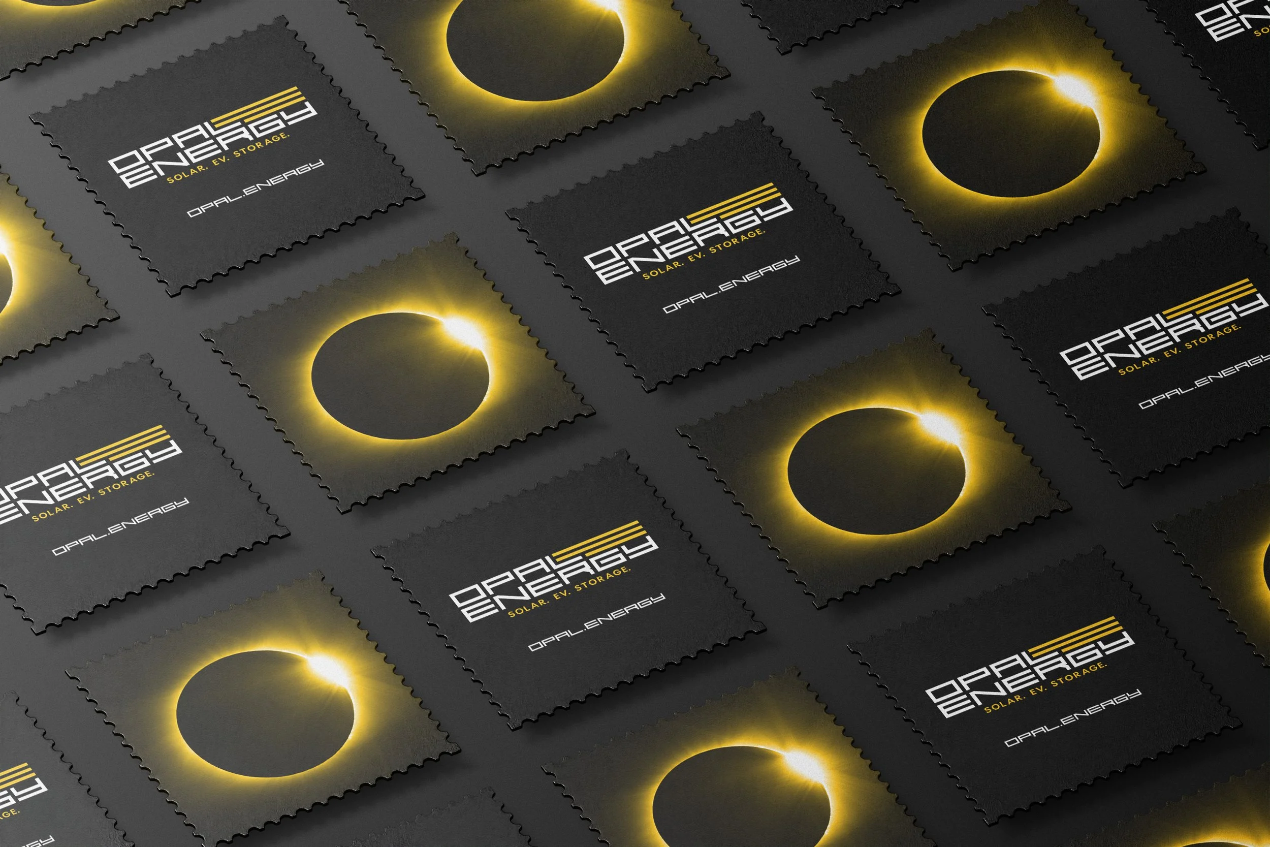 Multiple black square stickers featuring a solar eclipse with a glowing yellow ring, arranged in a grid pattern. The stickers have the words 'OPAL ENERGY' and 'SOLAR. EV. STORAGE.' written on them.