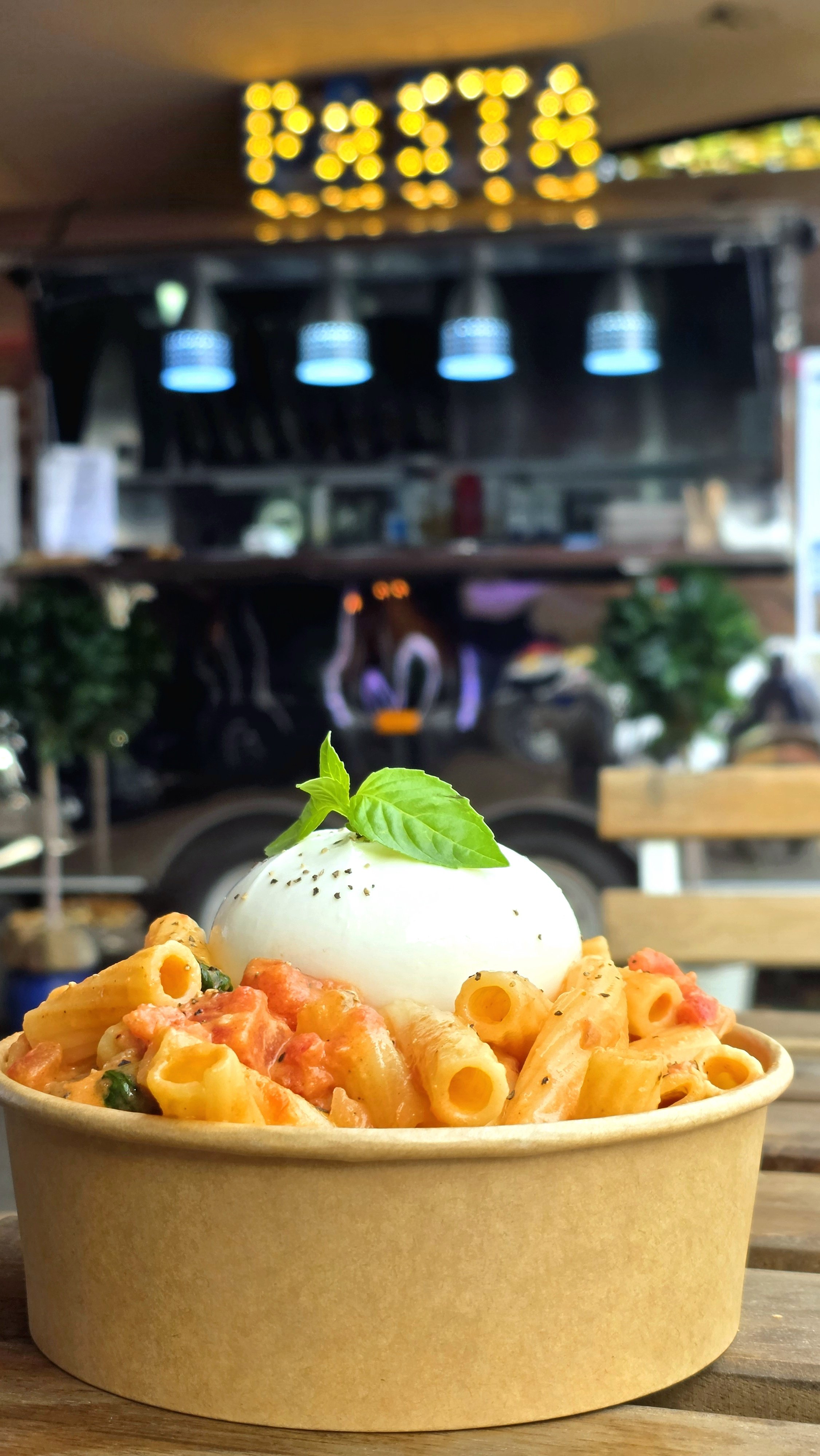 bowl of pasta covered in orangey vodka sauce