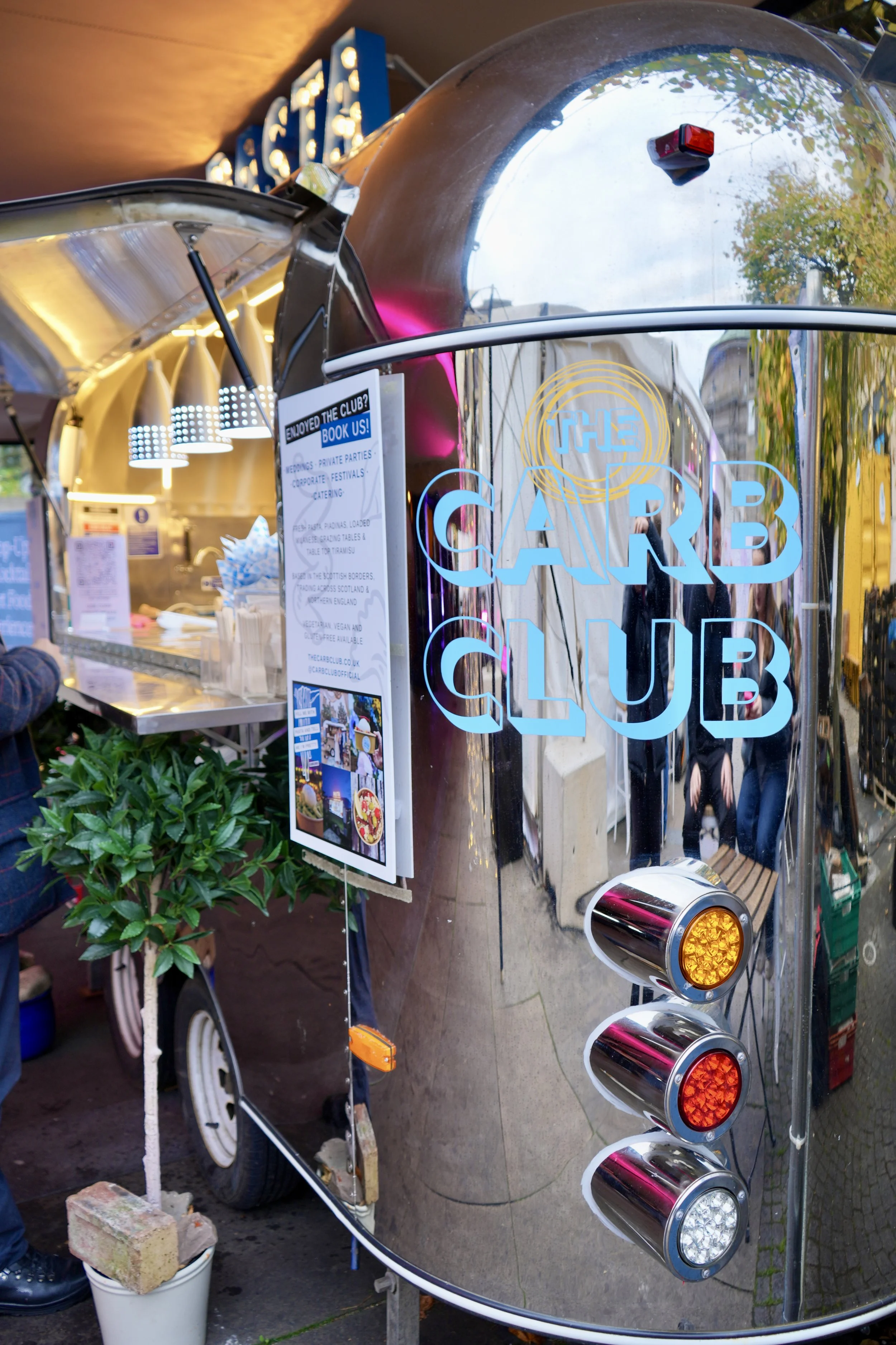 close up of a chrome food truck. Image shows the carb club logo on the side in blue