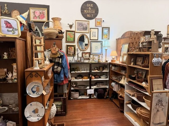 view of one of the vendors inside the shop window at the Vintage Hideaway showing antiques, and vintage items