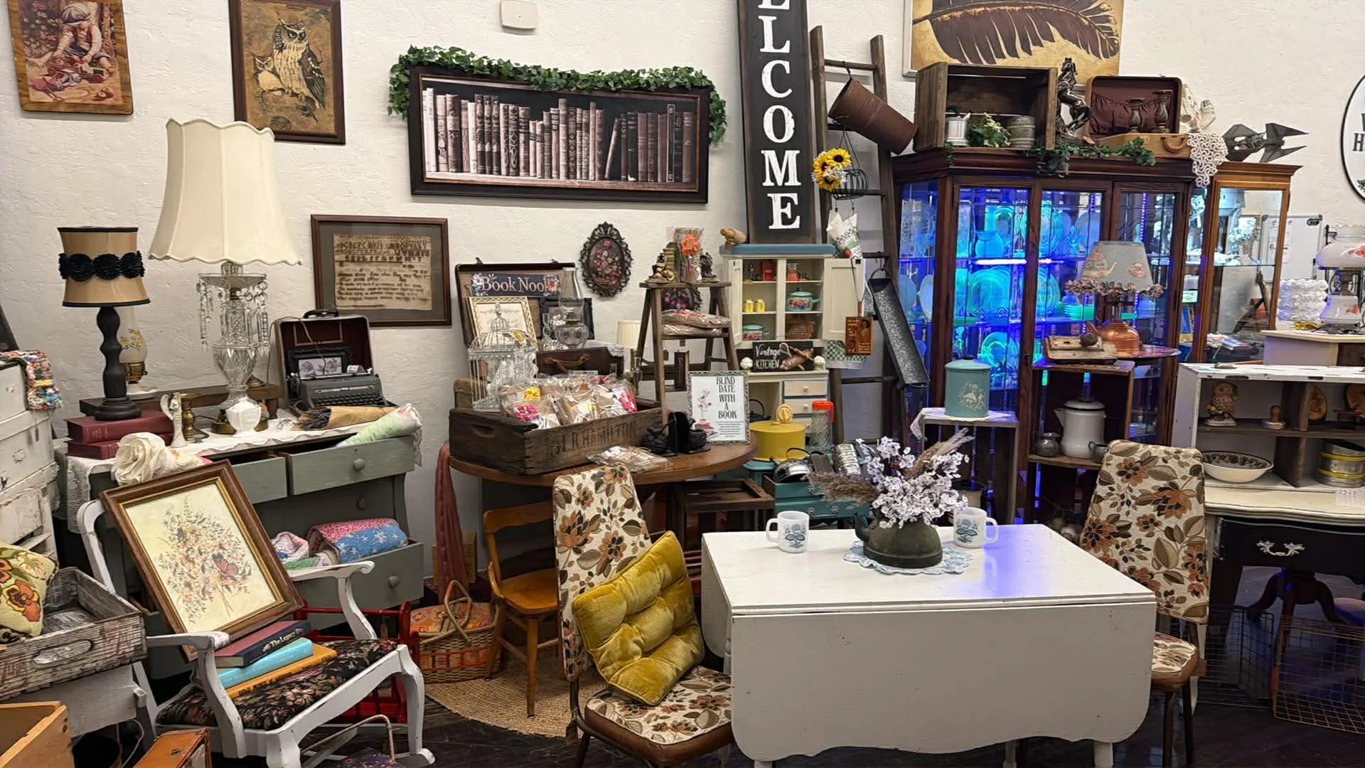 view of one of the vendors inside the shop window at the Vintage Hideaway showing antiques, and vintage items