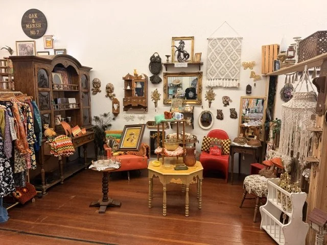 view of one of the vendors inside the shop window at the Vintage Hideaway showing antiques, and vintage items