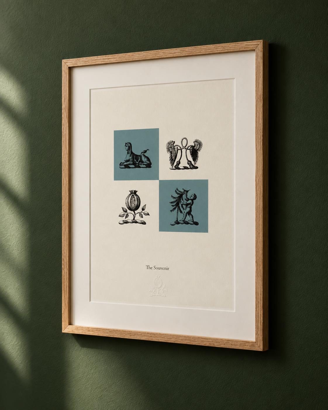 Framed artwork titled 'The Souvenir' featuring four stylized illustrations, each with a blue background, of a horse, a winged figure, a pomegranate, and a winged arm holding a snake, on a green wall.