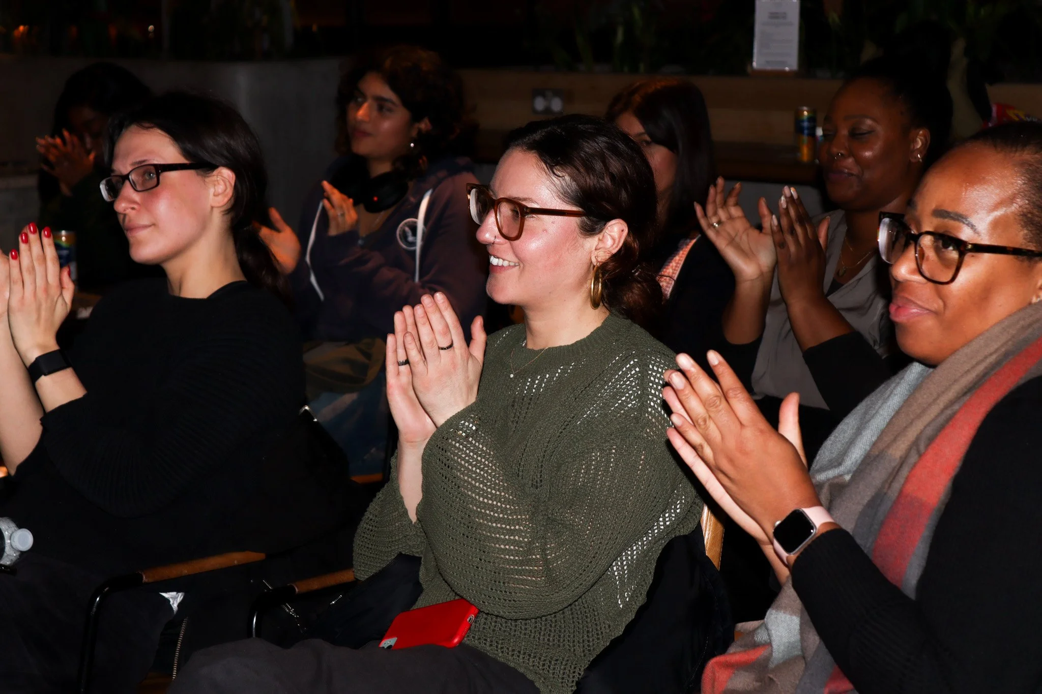 a group of women at an event spoken for was involved in hosting following the launch of Ray sang and Jenny Okolo's audio documentary with BBC world service. clapping after the panel has ended.