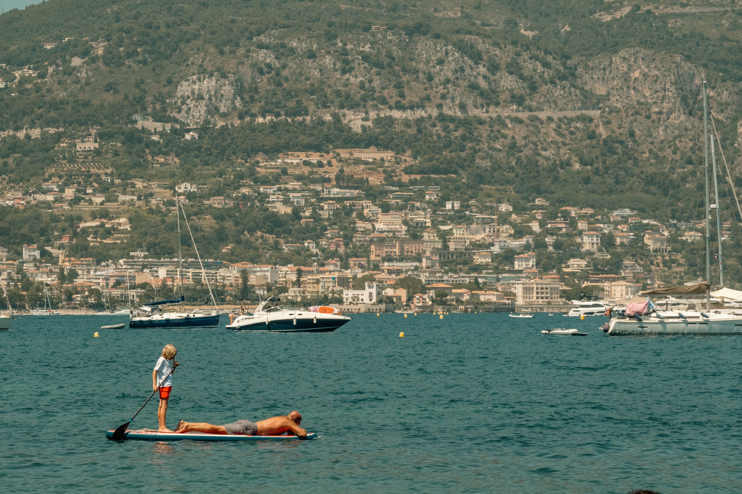 Father and Son Paddling in the French Sea