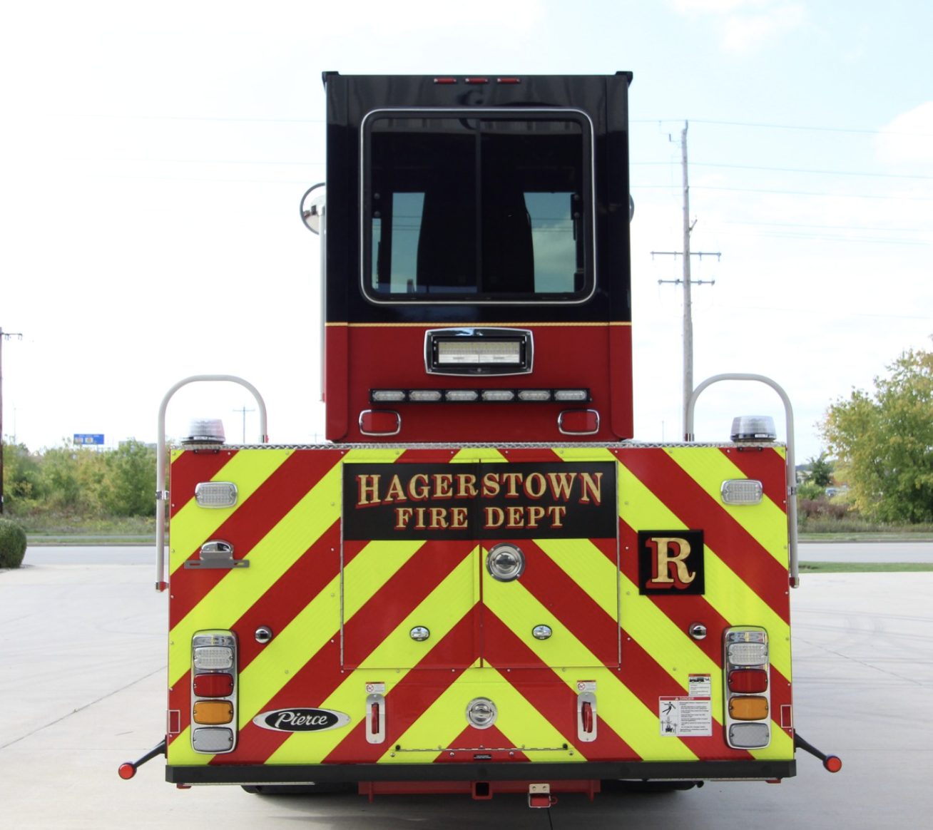 The back of a firetruck that reads "Hagerstown Fire Dept." The truck is in a parking lot with trees in the background. 
