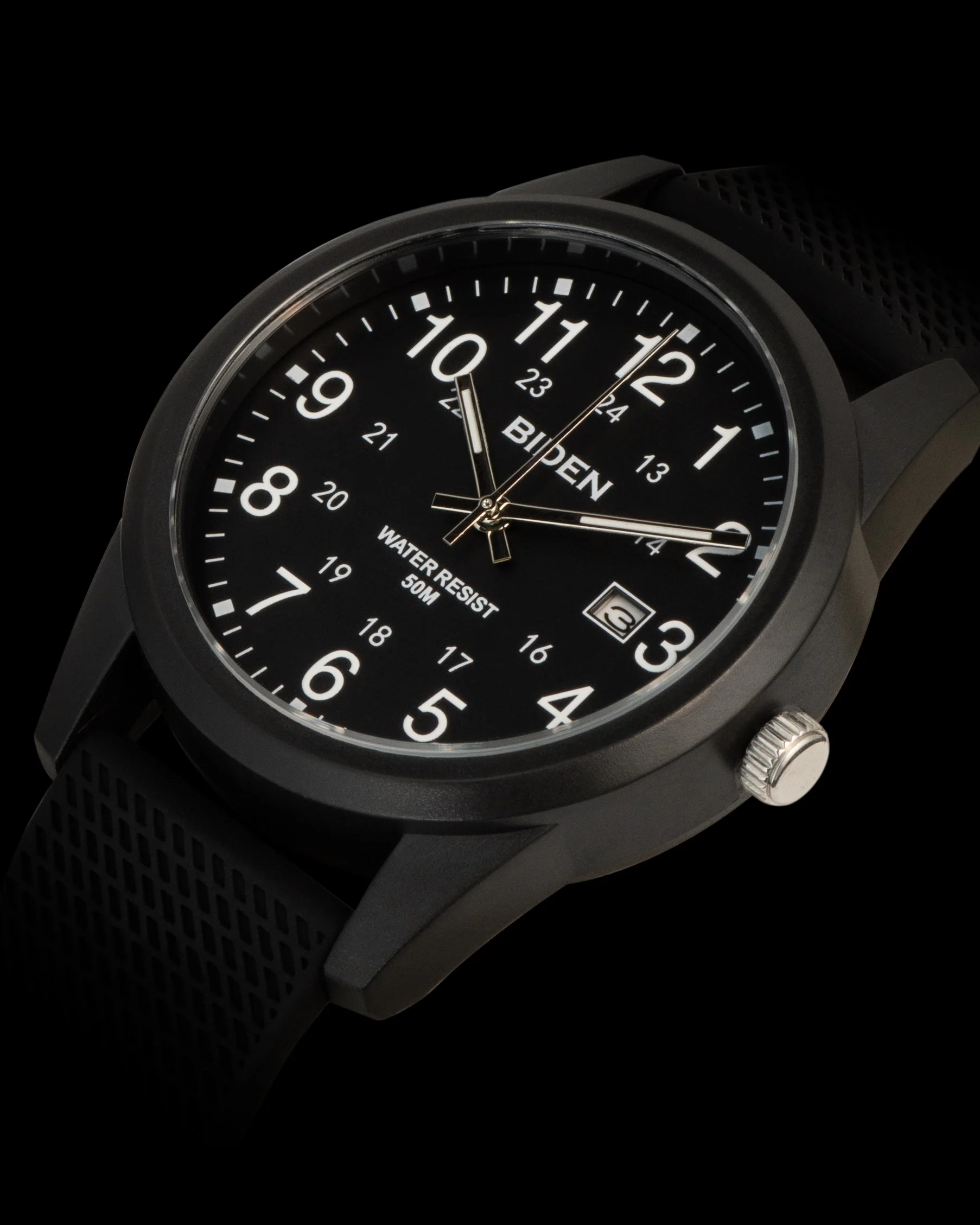 Close-up of a black wristwatch with a round face, displaying hours 1 to 12 and the date 23, with black band and silver crown, against a black background.