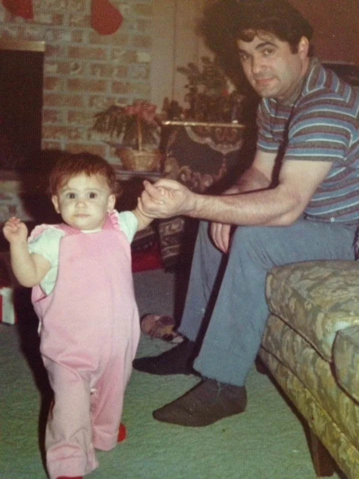 Childhood photograph of Marta with her father, Pappou, honoring the family roots and Greek heritage behind Elia.