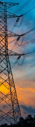 High-voltage electricity transmission lines and energy infrastructure representing power utilities and renewable energy operations.