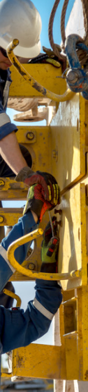 Personnel working on industrial construction equipment representing specialist construction and energy infrastructure projects.