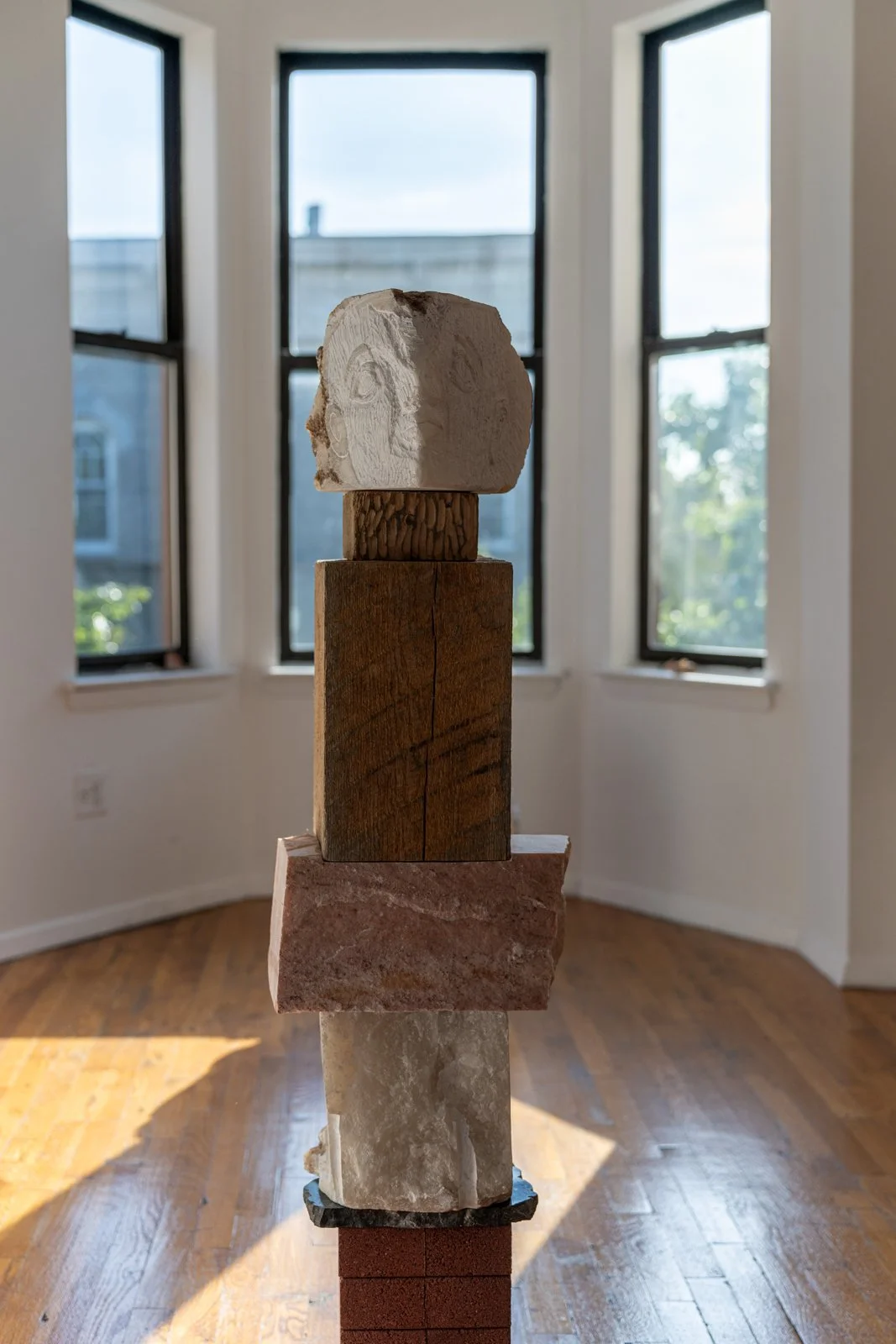 I Searched For You Inside Homes And On Endless Roads (Faces), 2024, Alabaster, earth, found wood, marble, brick, 50” X 12.5” X 9.5"

Photo credit: Benjamin Koditschek