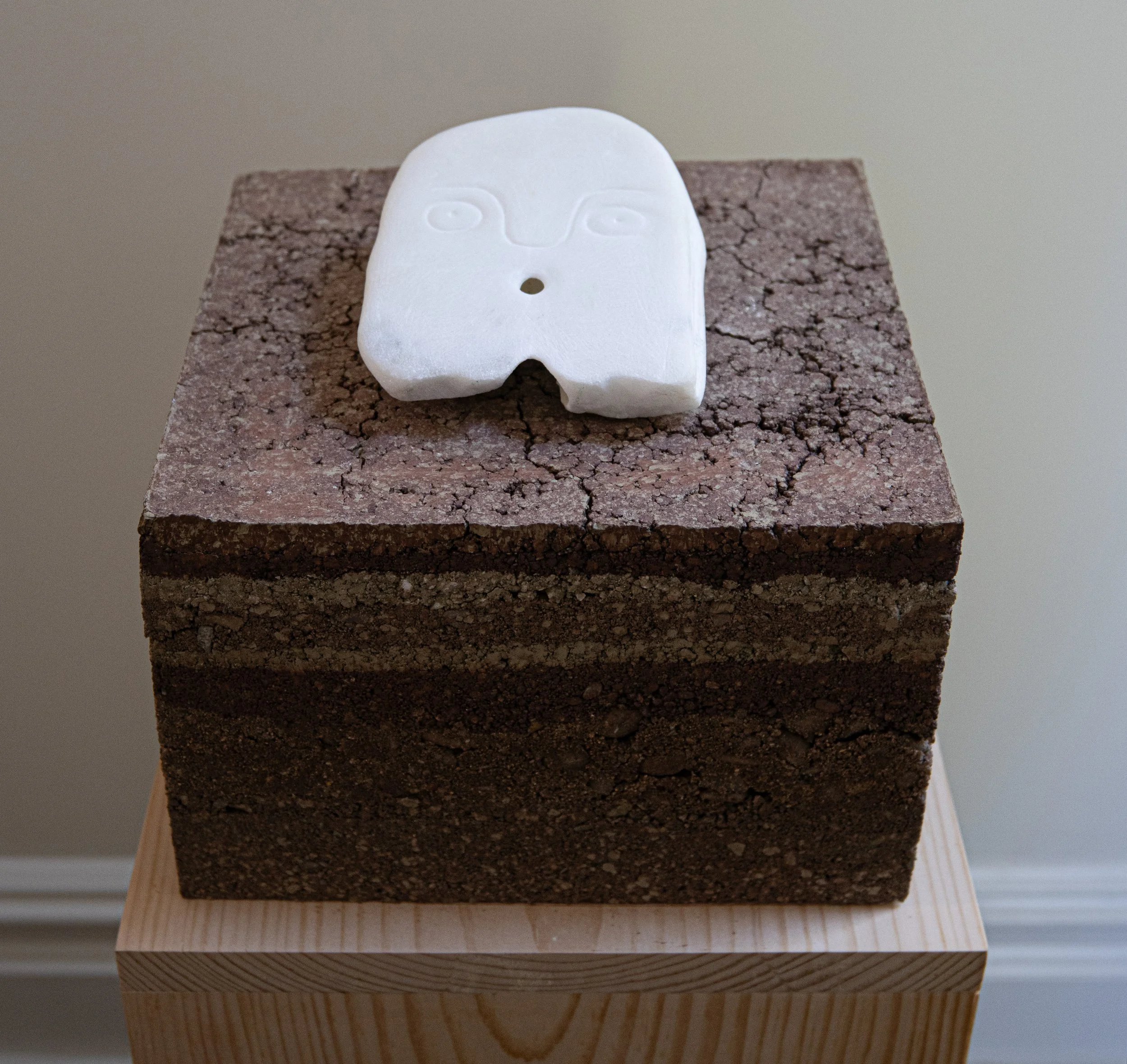 Ghost (What I cannot grasp of your voice), 2025, marble, earth, pine pedestal, 31” X 11.5” X 11”

Photo by Arseny Pekurovsky