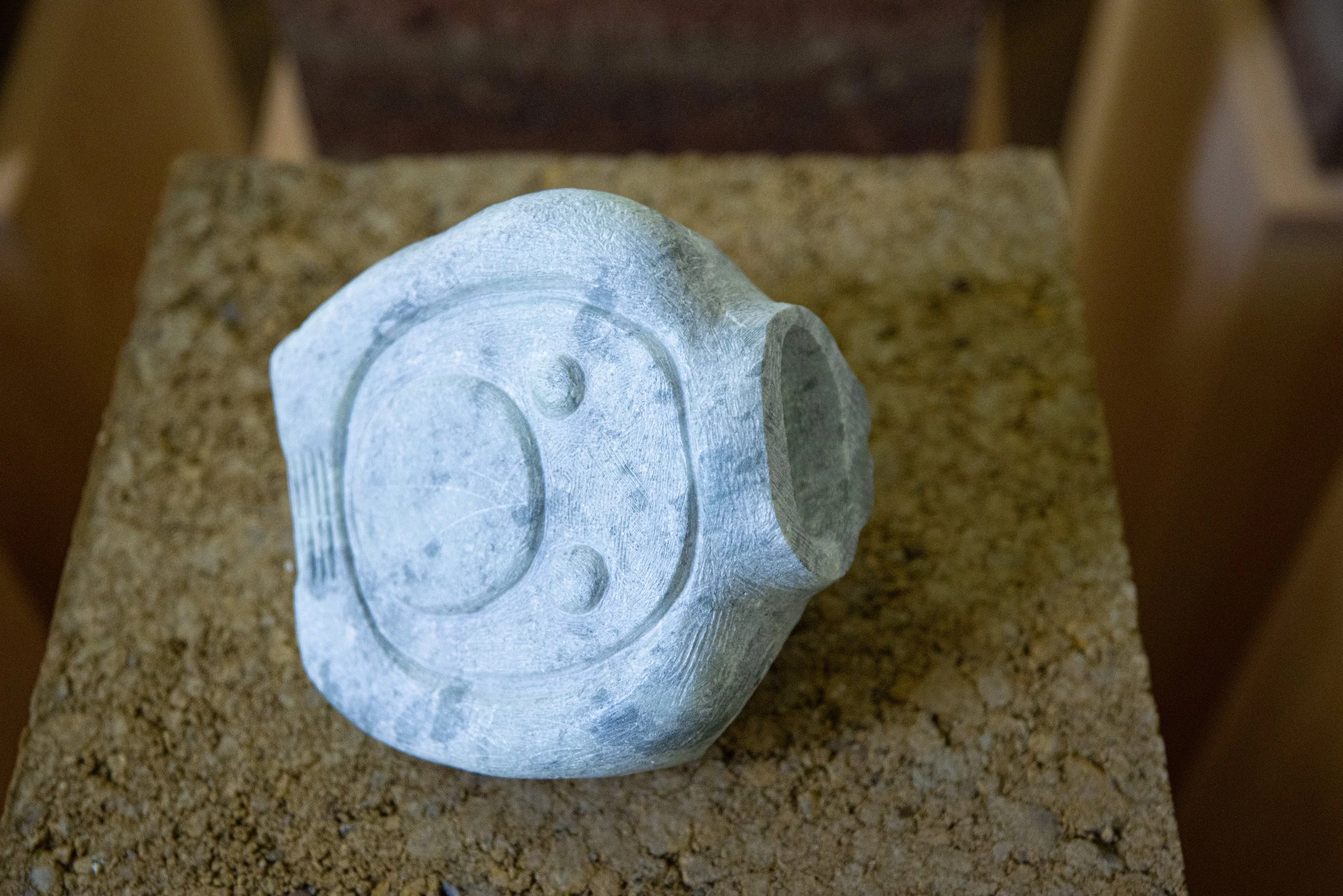 Vessel (The book is a reflection that never arrives… there is no touching), 2025, soapstone, earth, pine pedestal, 34” X 11.5” X 11” (detail i)

