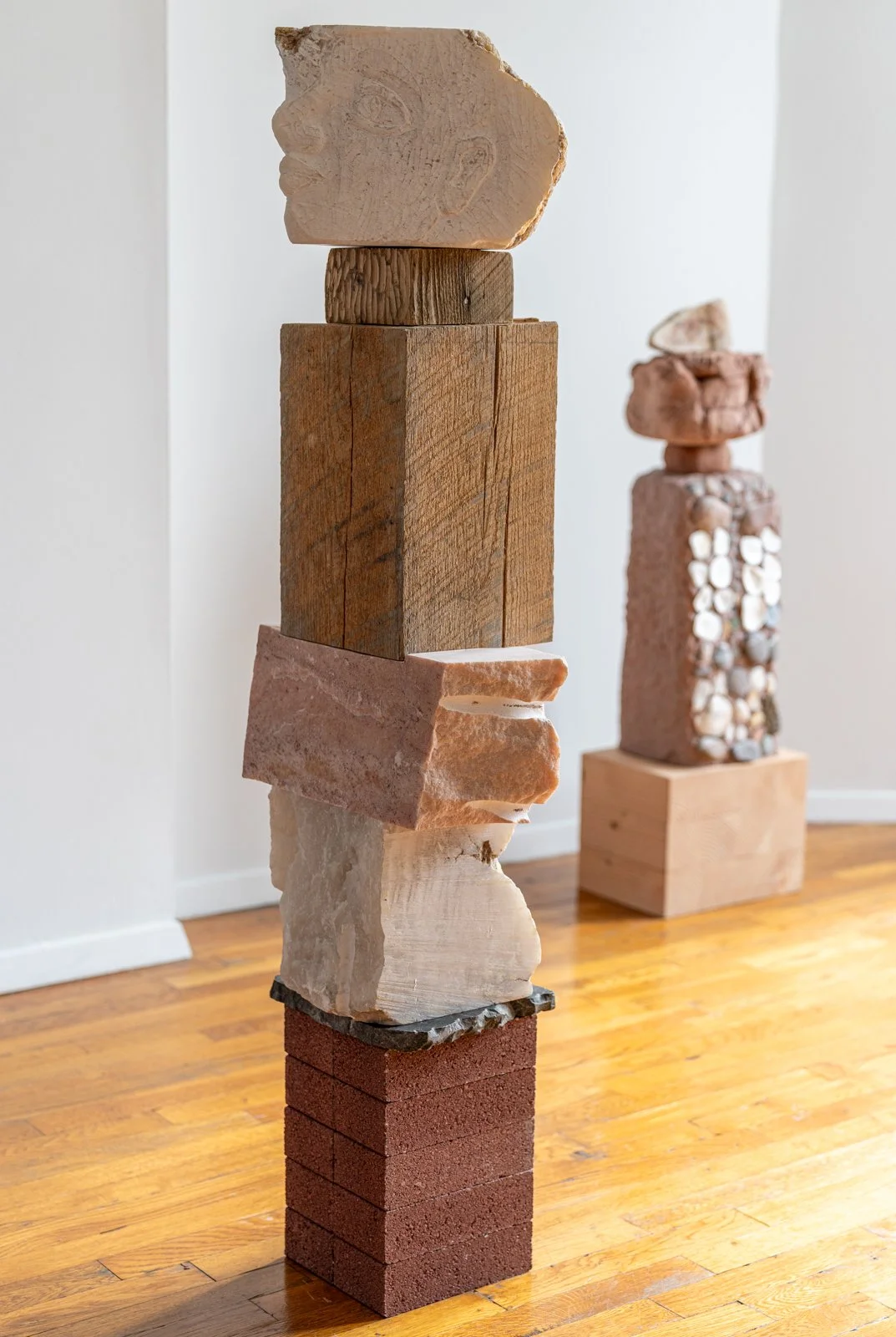 I Searched For You Inside Homes And On Endless Roads (Faces), 2024, Alabaster, earth, found wood, marble, brick, 50” X 12.5” X 9.5"

Photo credit: Benjamin Koditschek