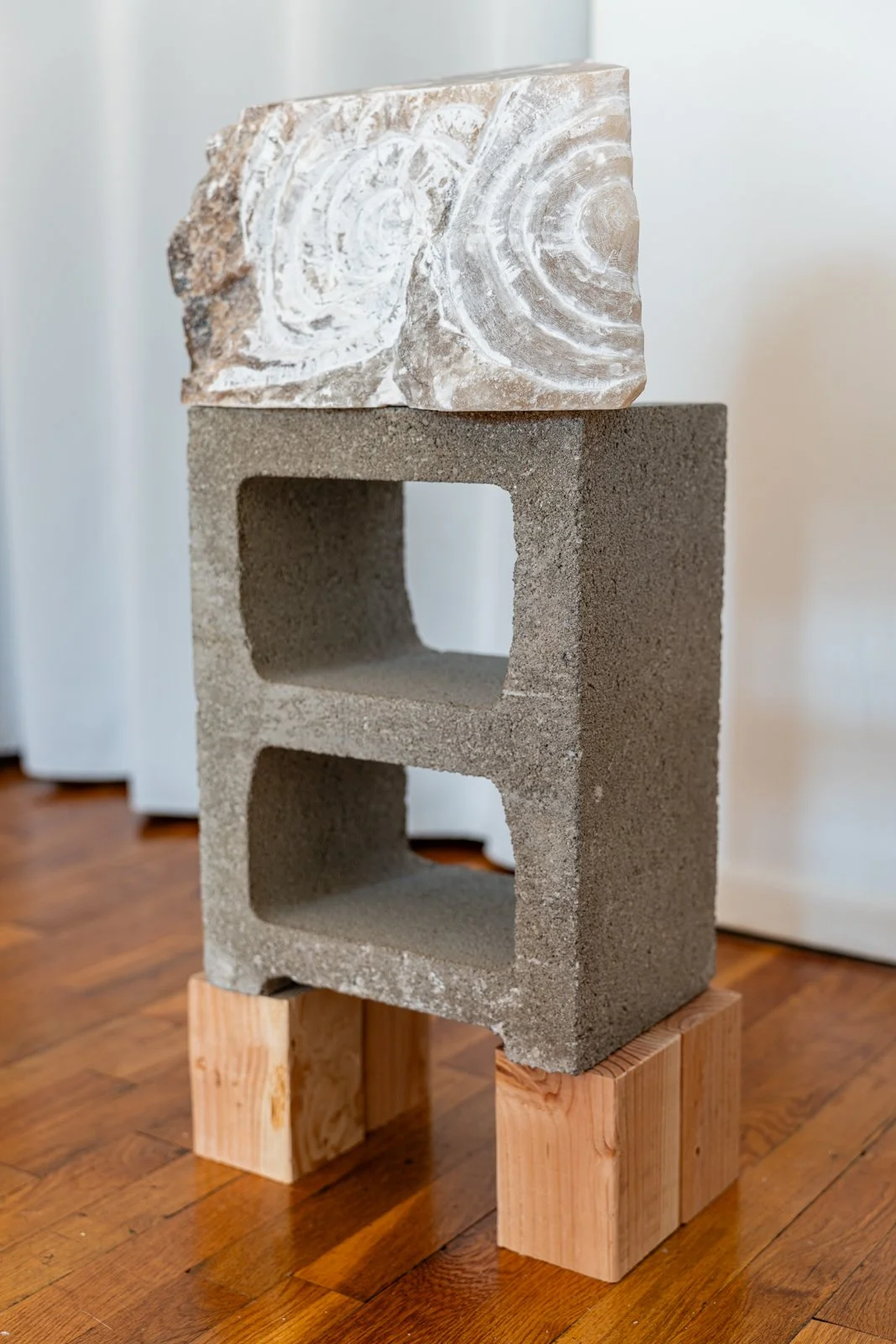 Water Swirled And You Asked Whether Vision Could Be Whittled On The Edge of Things, Where The Center Moved And Kept Traveling (Vortex, Fossil), 2024, Alabaster, Cinder block, wood, 21.5” X 13” X 7.5”

Photo credit: Benjamin Koditschek
