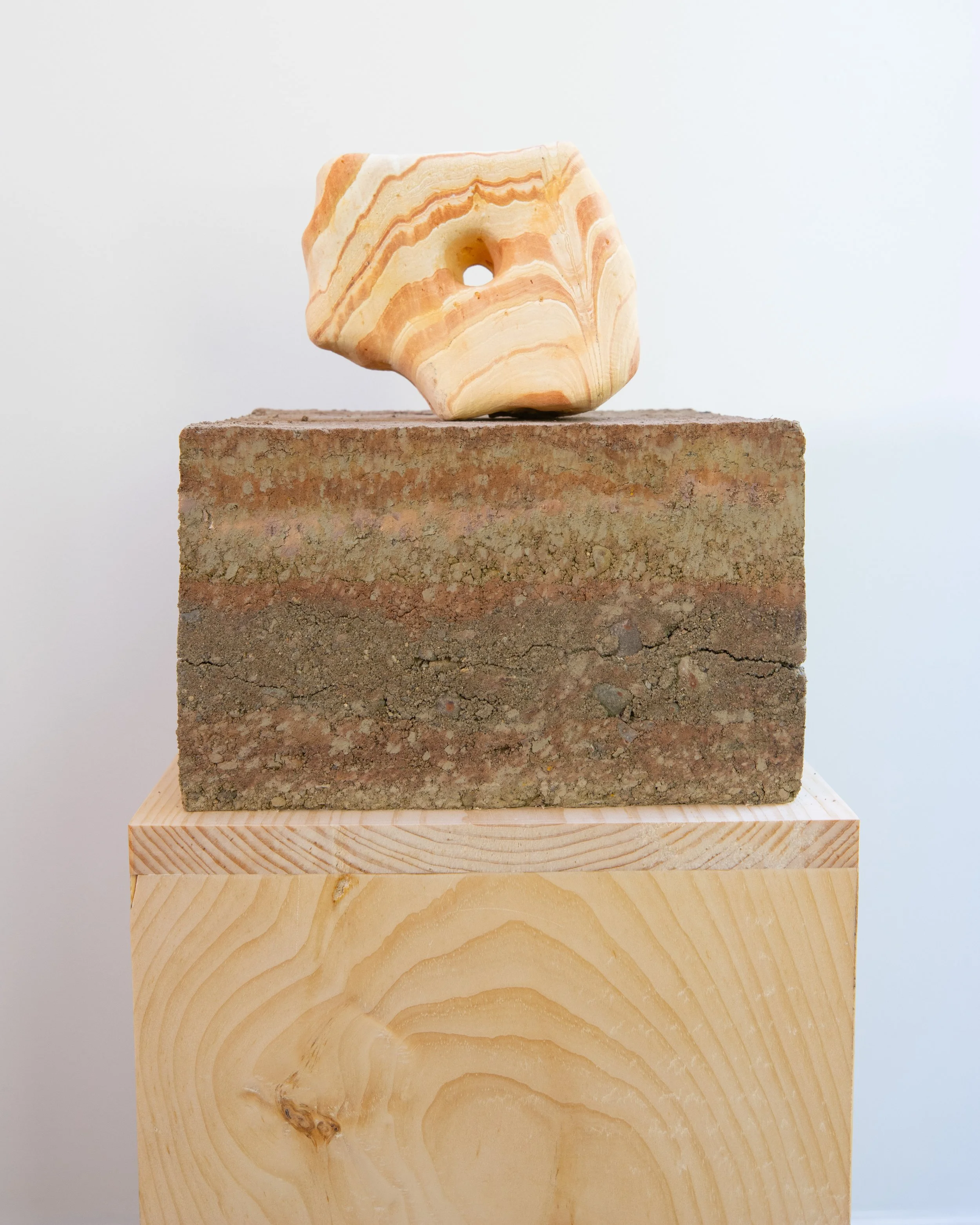 Hole/Through (One by one, to see), 2025, rhyolite, earth, pine pedestal, 36” X 11.5” X 11”, (detail i)

Photo by Arseny Pekurovsky