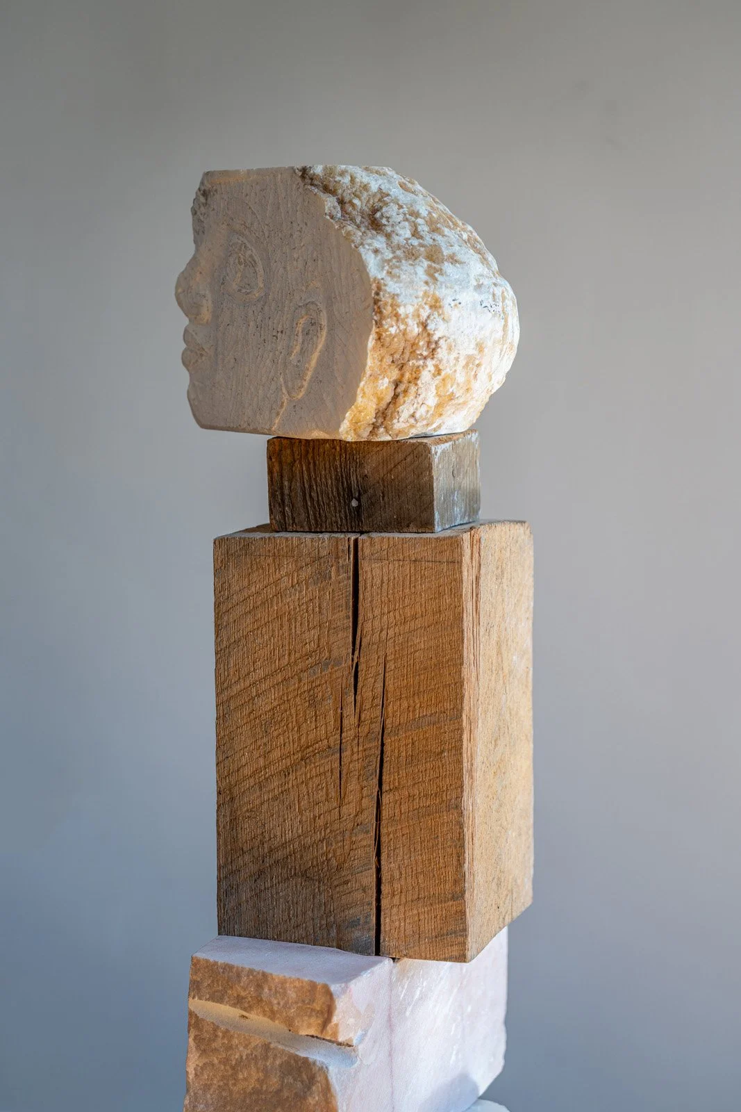 I Searched For You Inside Homes And On Endless Roads (Faces), 2024, Alabaster, earth, found wood, marble, brick, 50” X 12.5” X 9.5," (Detail i)

Photo credit: Benjamin Koditschek