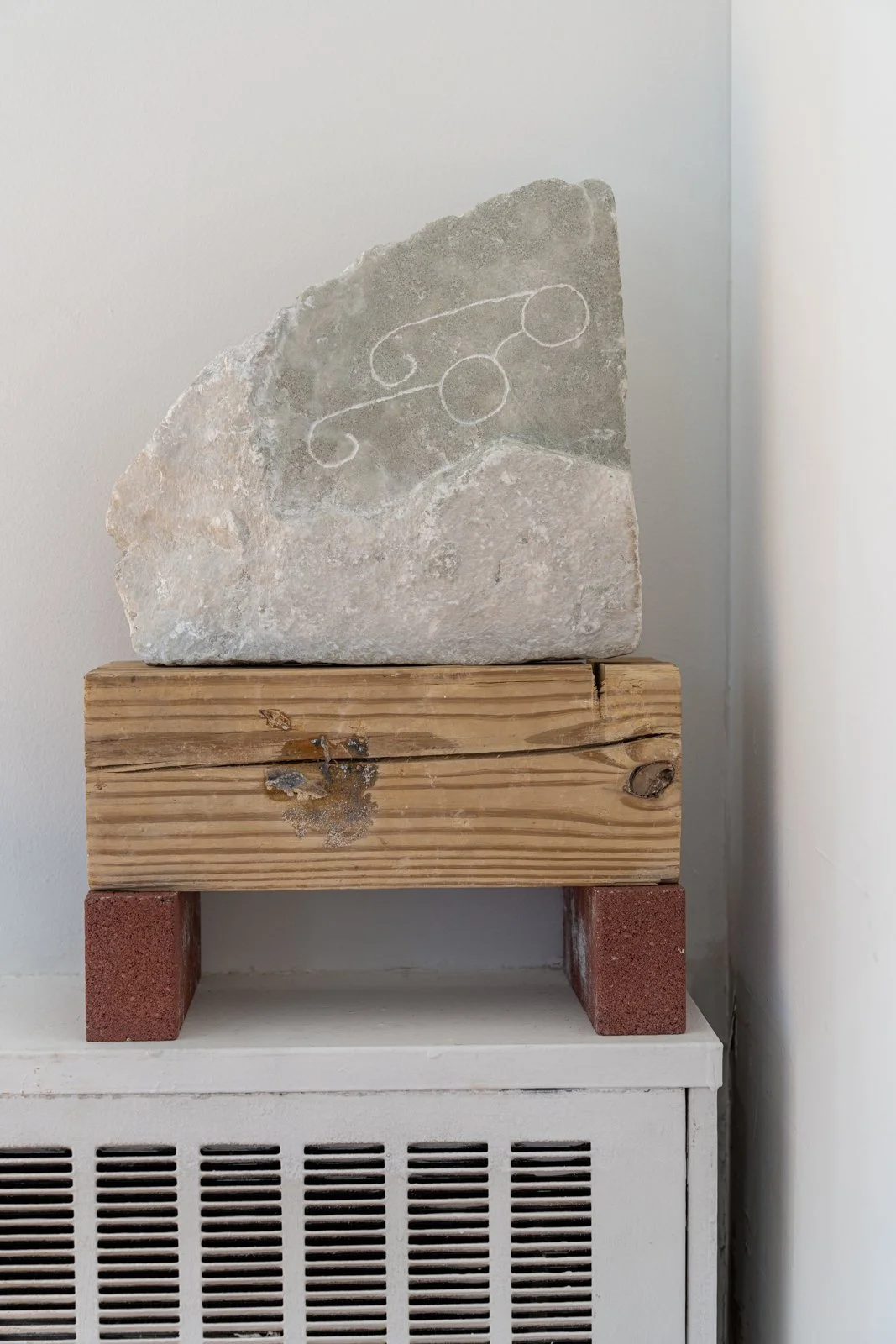 She Got Off The Bus And Walked In A Zone Where At Her Feet She Found A Stone And In The Stone She Saw An Image Of Glasses (Glasses), 2024, Alabaster, wood, brick, 21” X 15” X 7.5”

Photo credit: Benjamin Koditschek