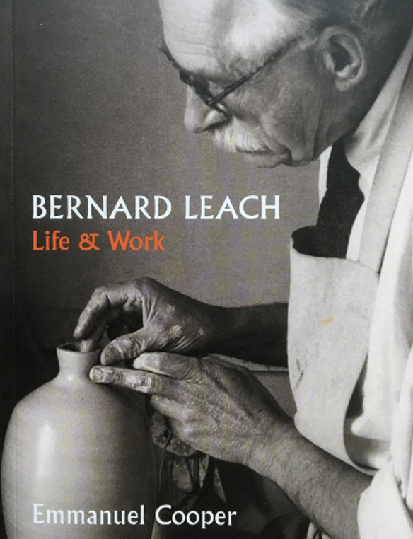 Cover of a book featuring a black and white photo of an elderly man with glasses and a mustache working on a ceramic vase, with the title "Bernard Leach: Life & Work" and author Emmanuel Cooper.